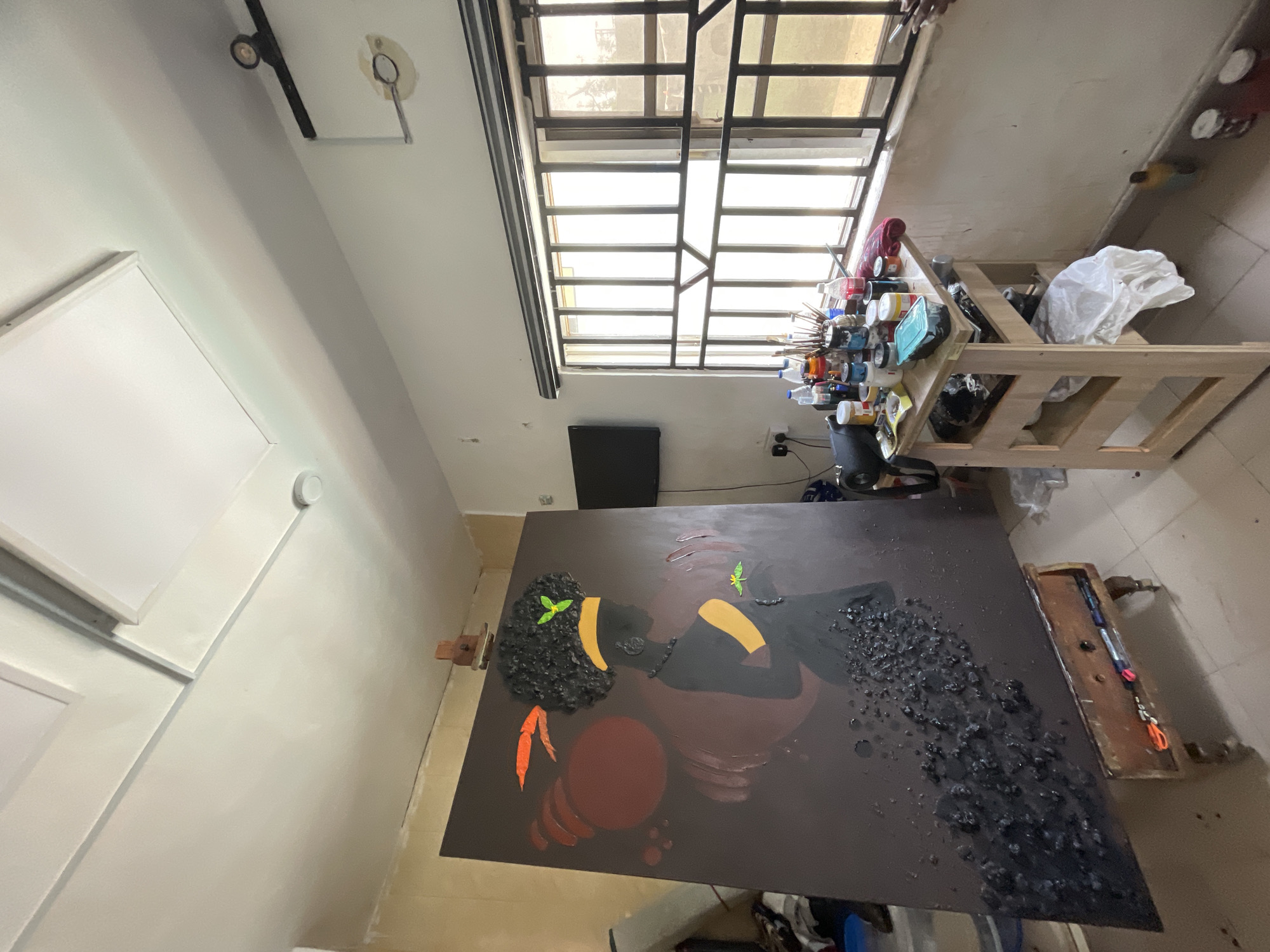 Artist paints Black woman portrait in Ado studio