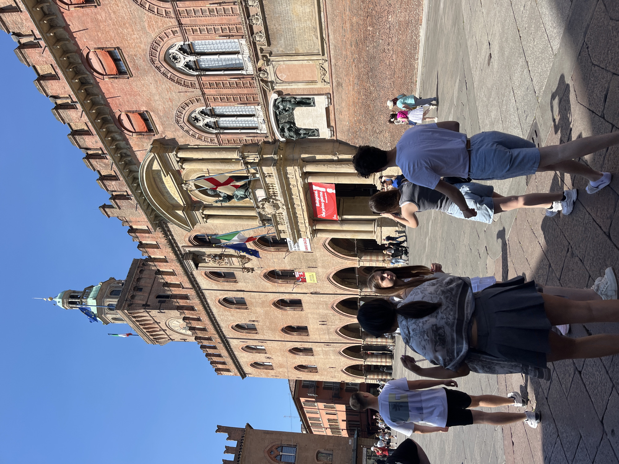 Morning life unfolds across Bologna's historic squares and landmarks