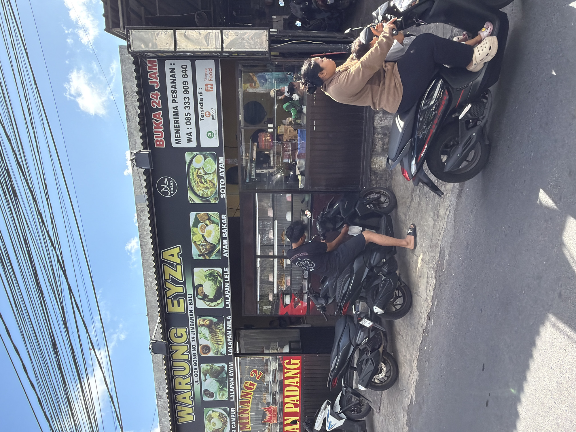 Morning trash collection and street traffic near Jimbaran, Bali