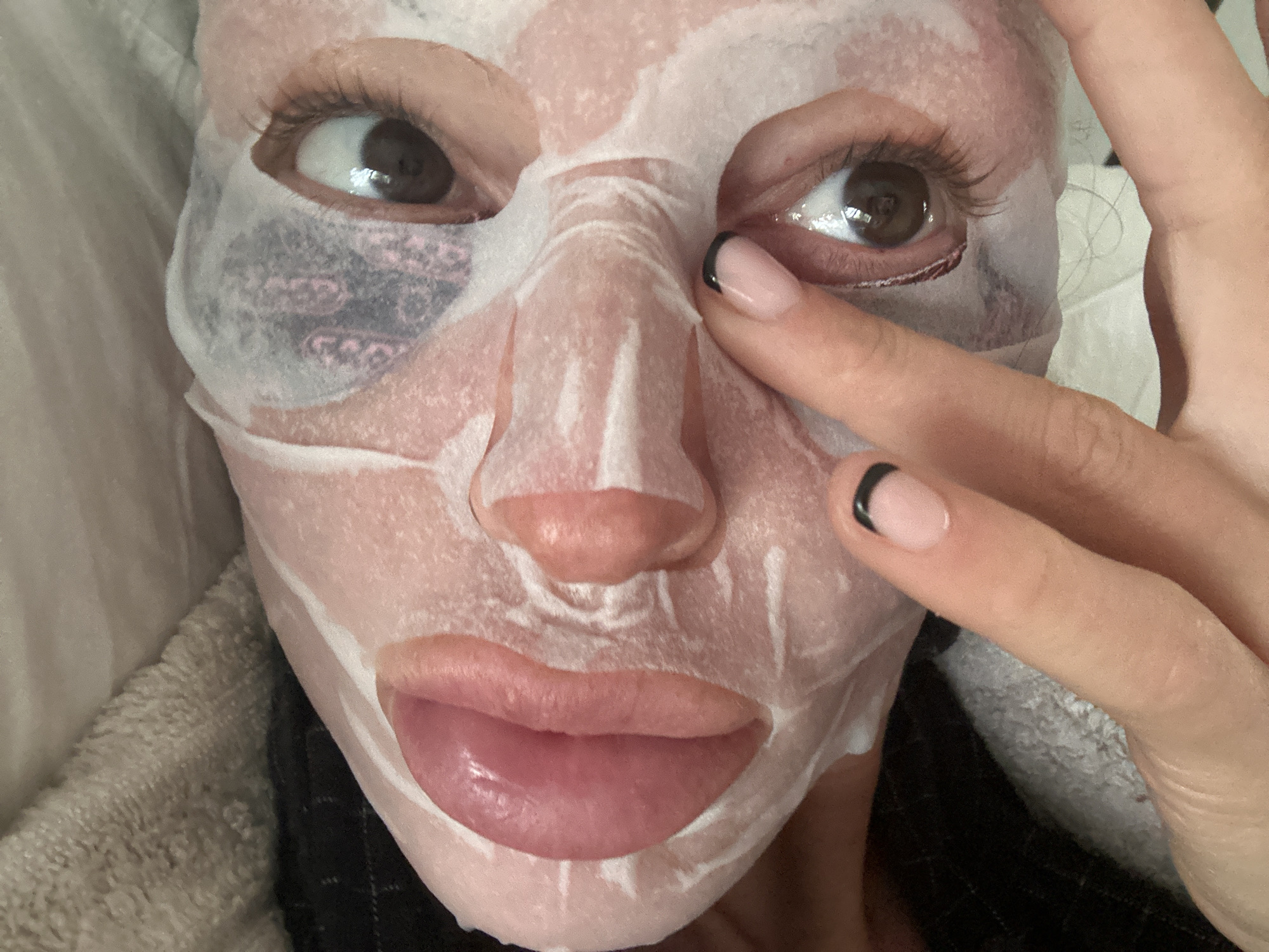 Person applies facial sheet mask in Tunbridge Wells