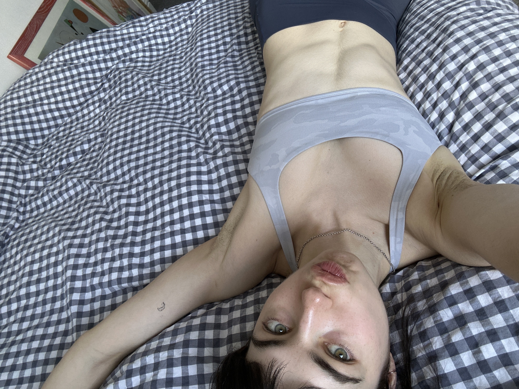 Person resting on bed observed in London residential setting