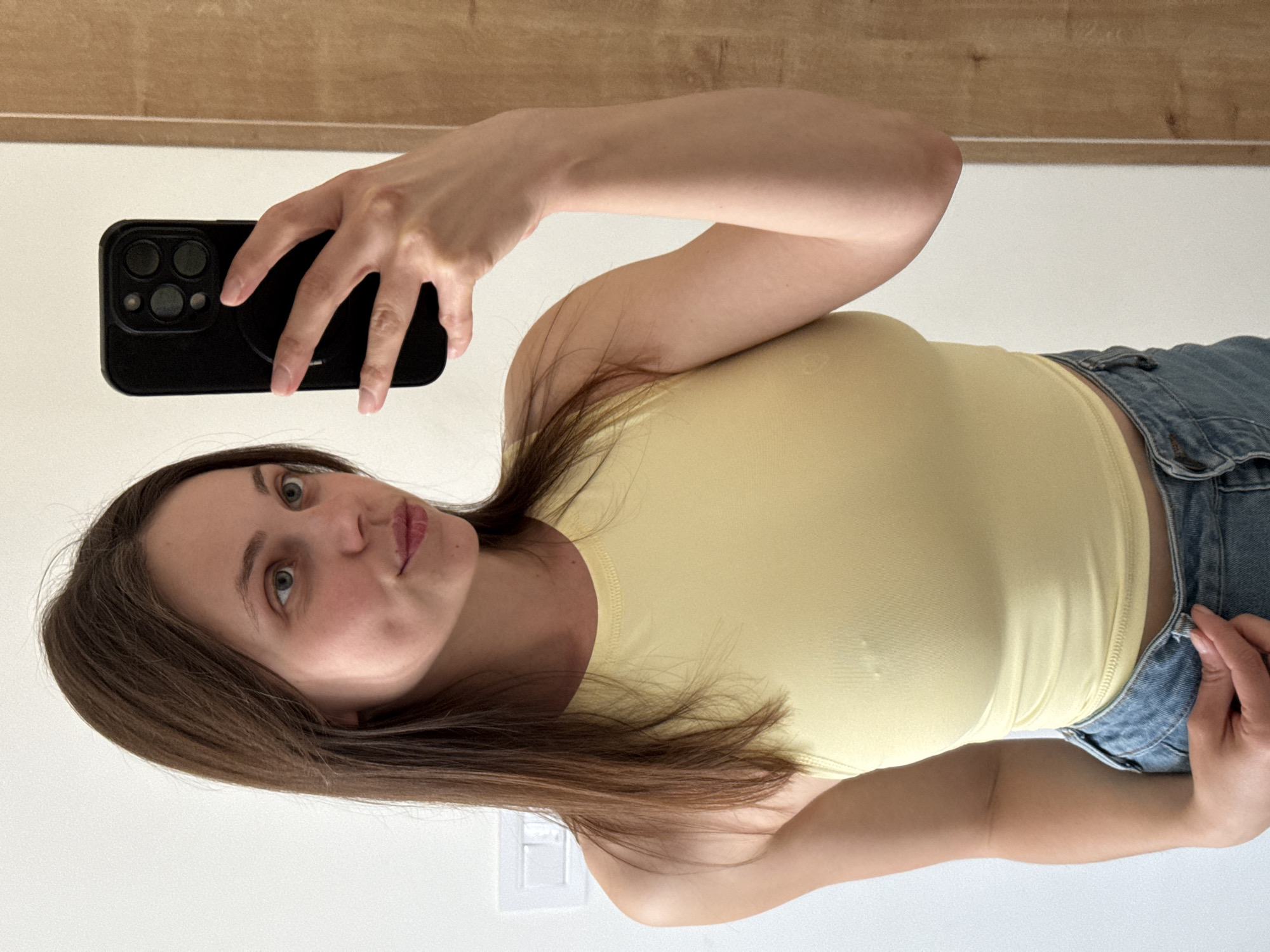 Woman takes selfies in Belgrade residential hallway