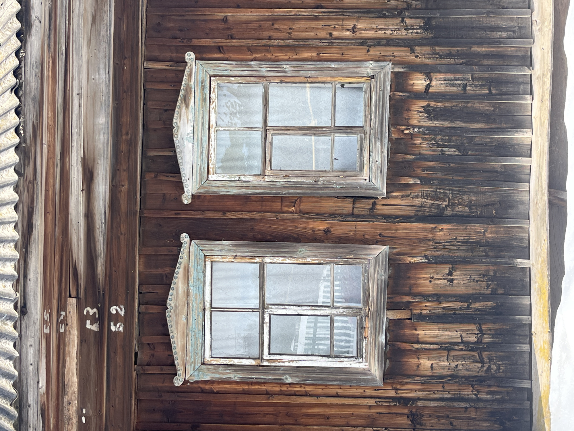 Wooden building with decorated windows documented in rural Russia
