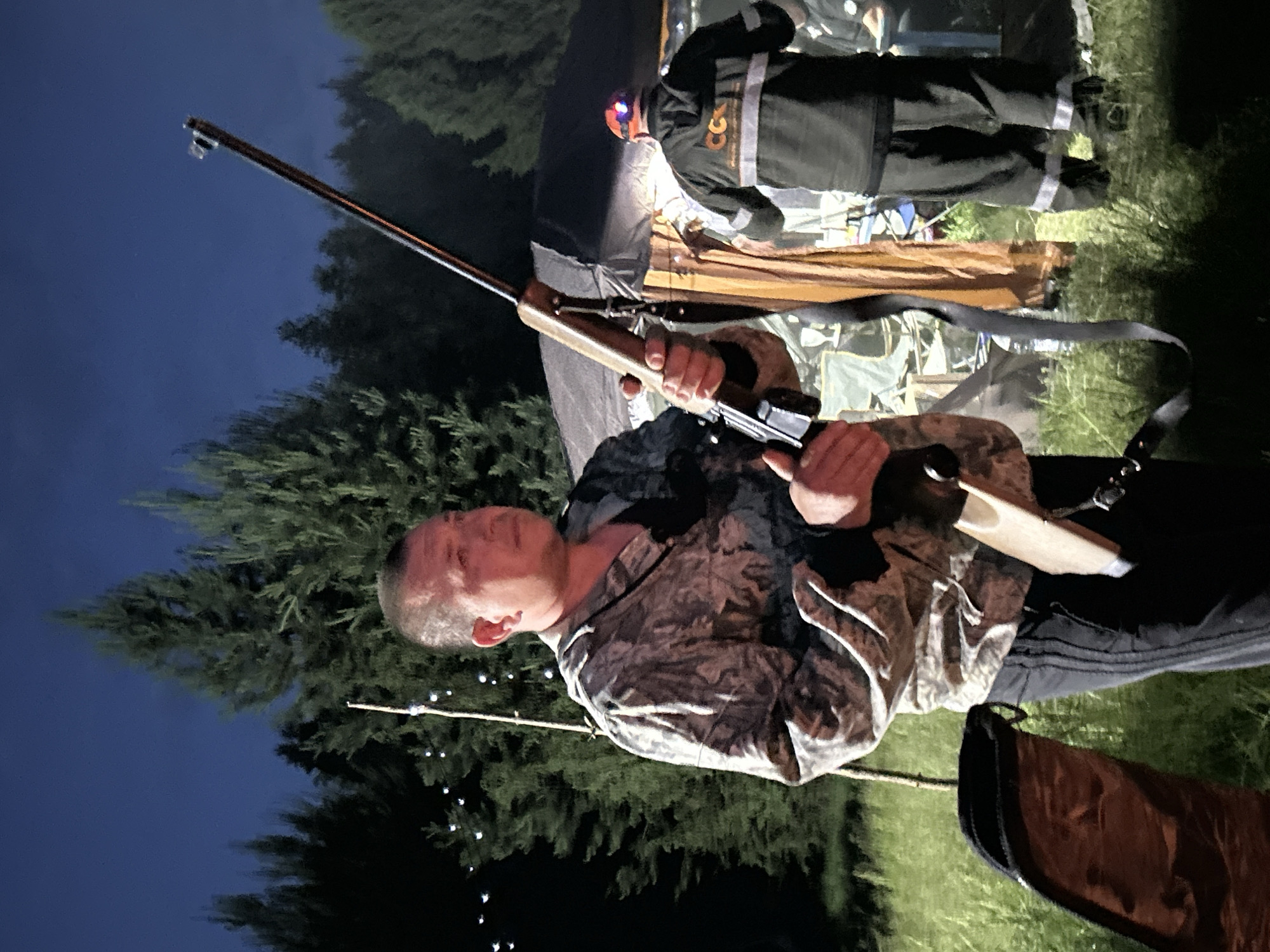 Camping group enjoys sunset activities by lake in Plishkino