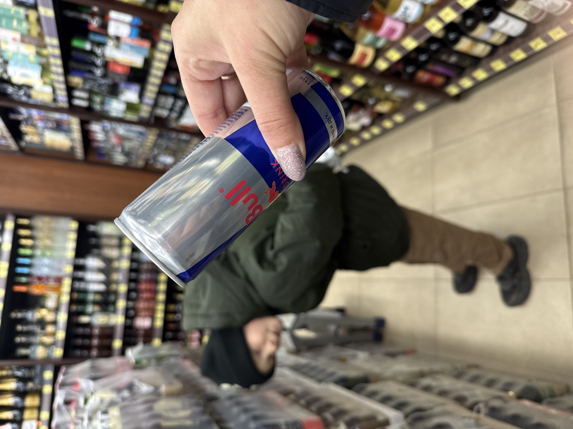Person holds Red Bull in Russian store