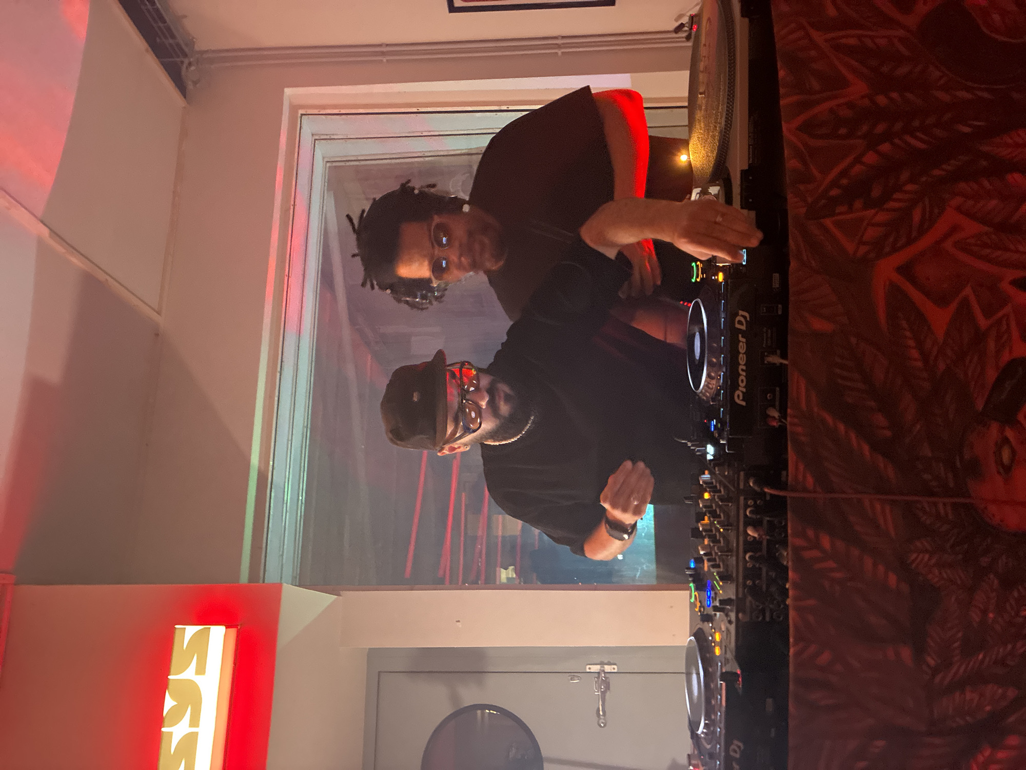 Two men operate DJ setup in Barcelona