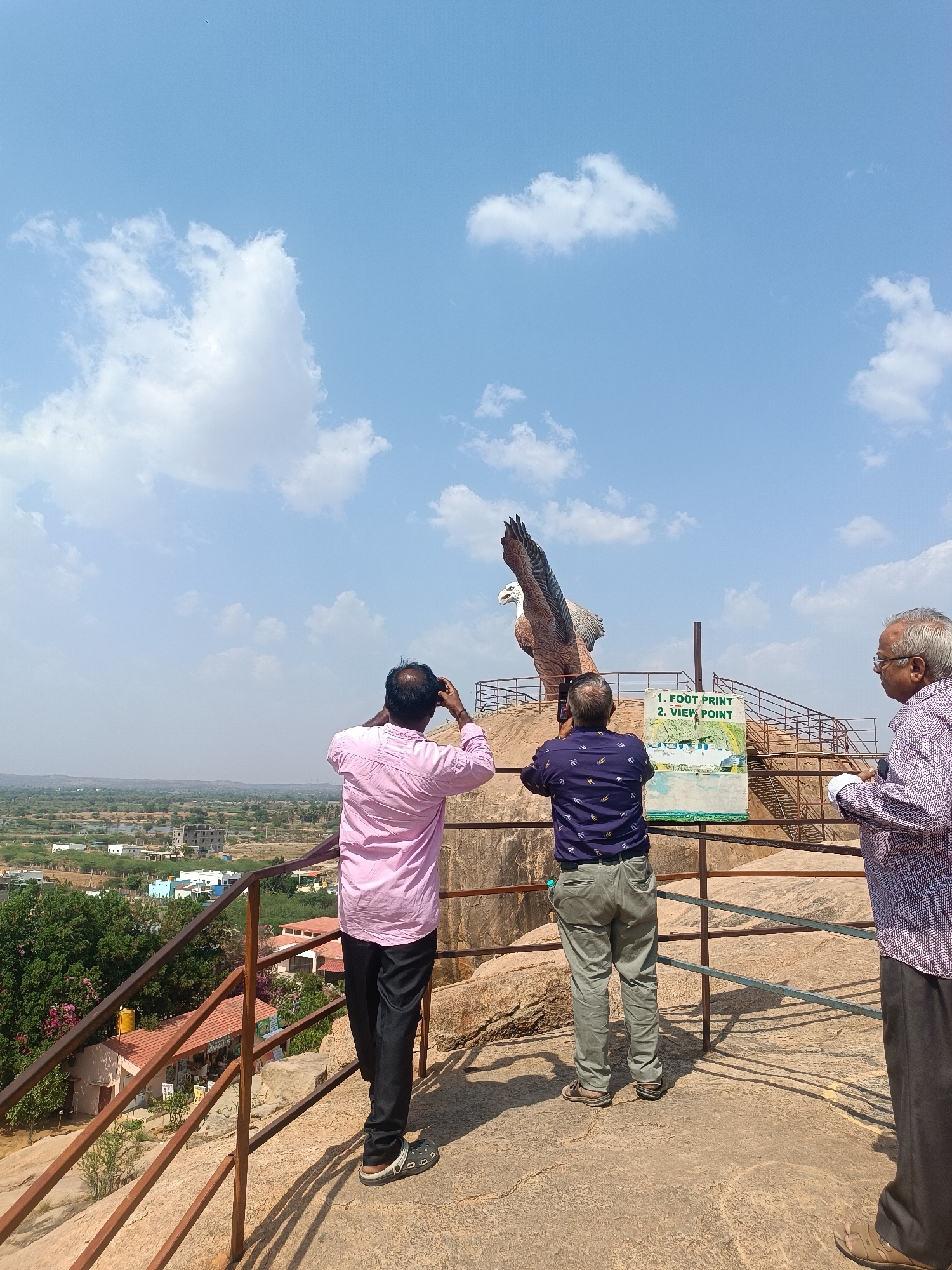 Man feeds monkeys in Lepakshi park wearing camouflage outfit