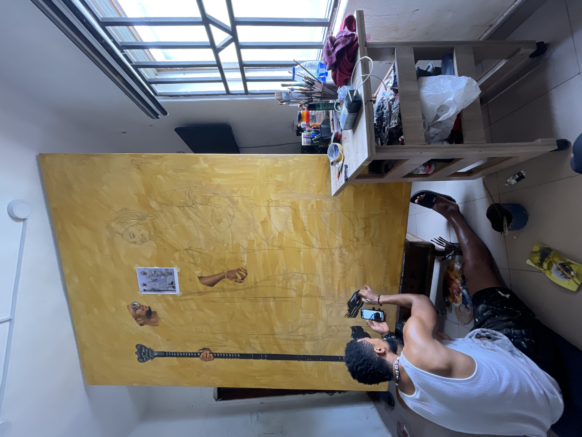 Artist creates large canvas painting in Ado studio