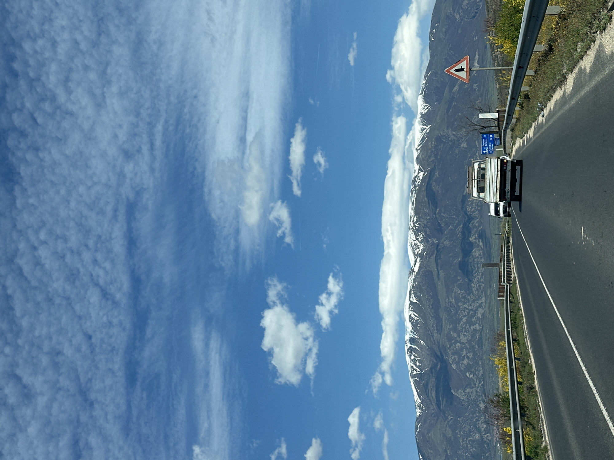 White truck travels mountain highway near Banya, Bulgaria