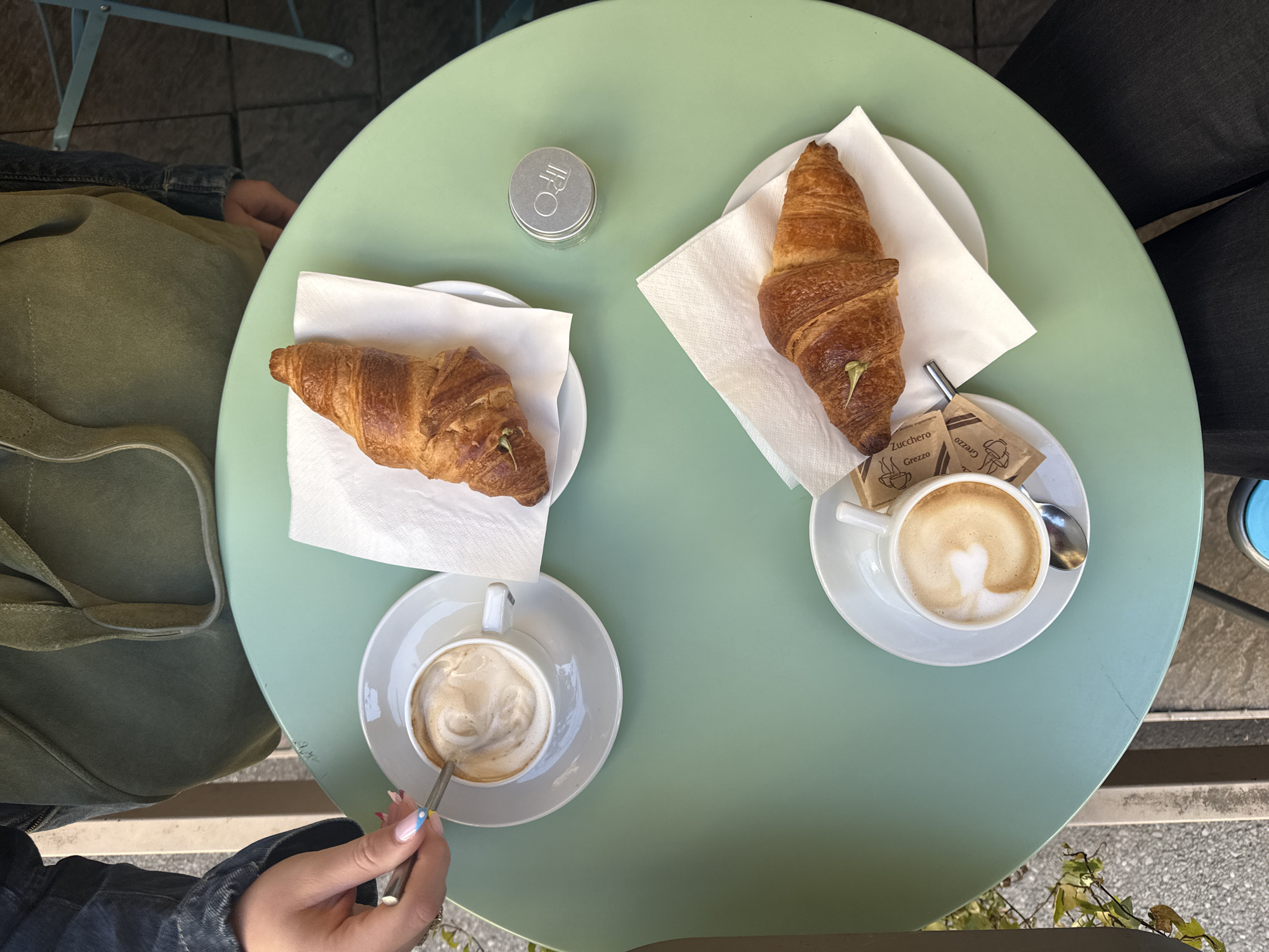 Morning café breakfast shared in Milan outdoor setting
