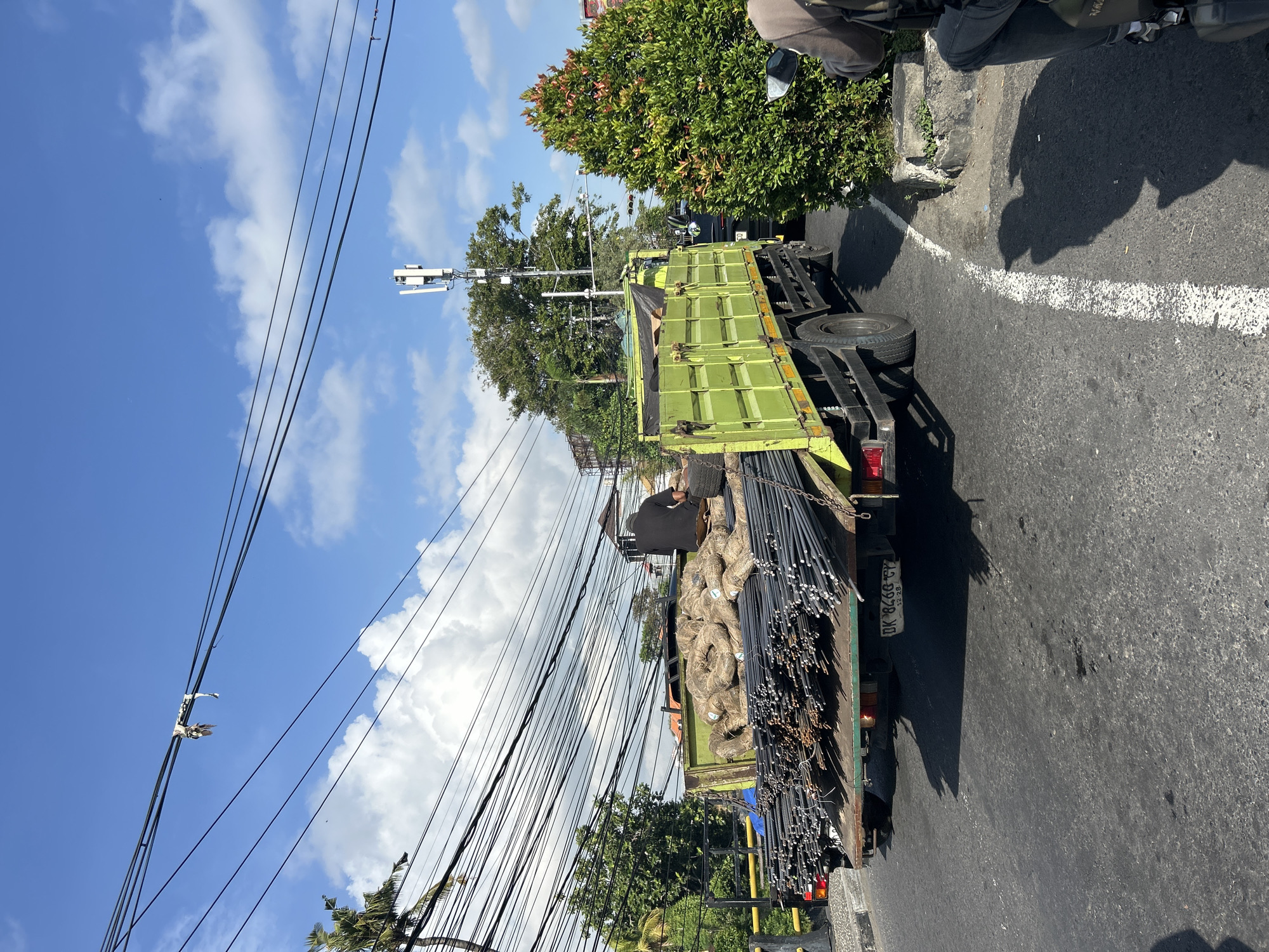Heavy midday traffic at a busy Denpasar intersection