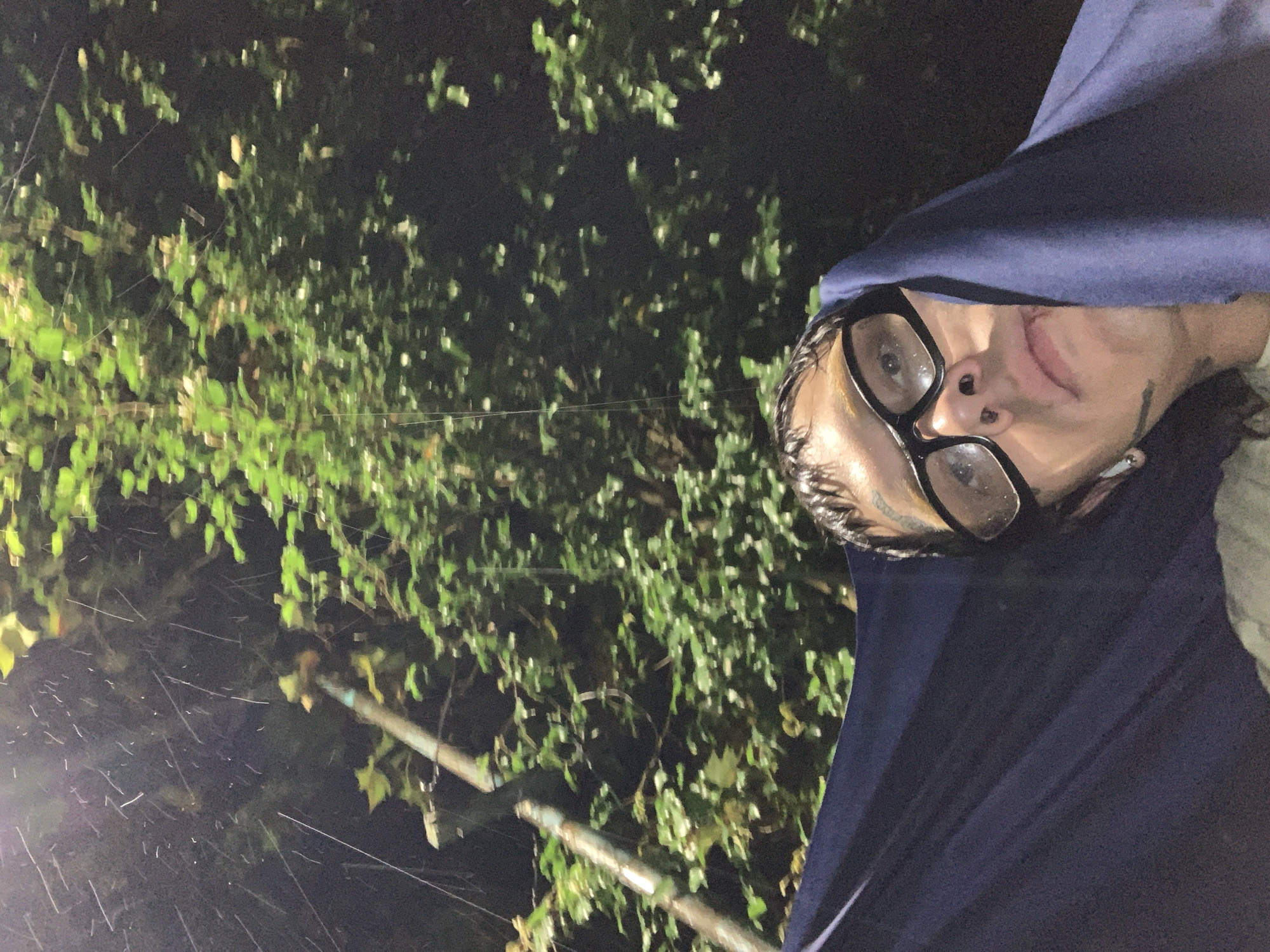 Person caught in nighttime rain on Vicente López street
