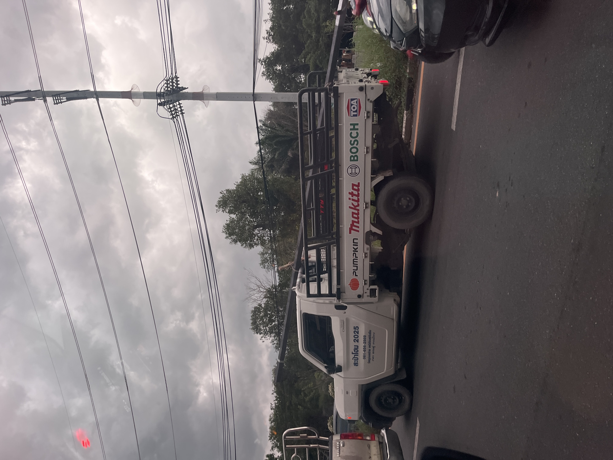 Traffic jam forms under storm clouds in Si Sunthon