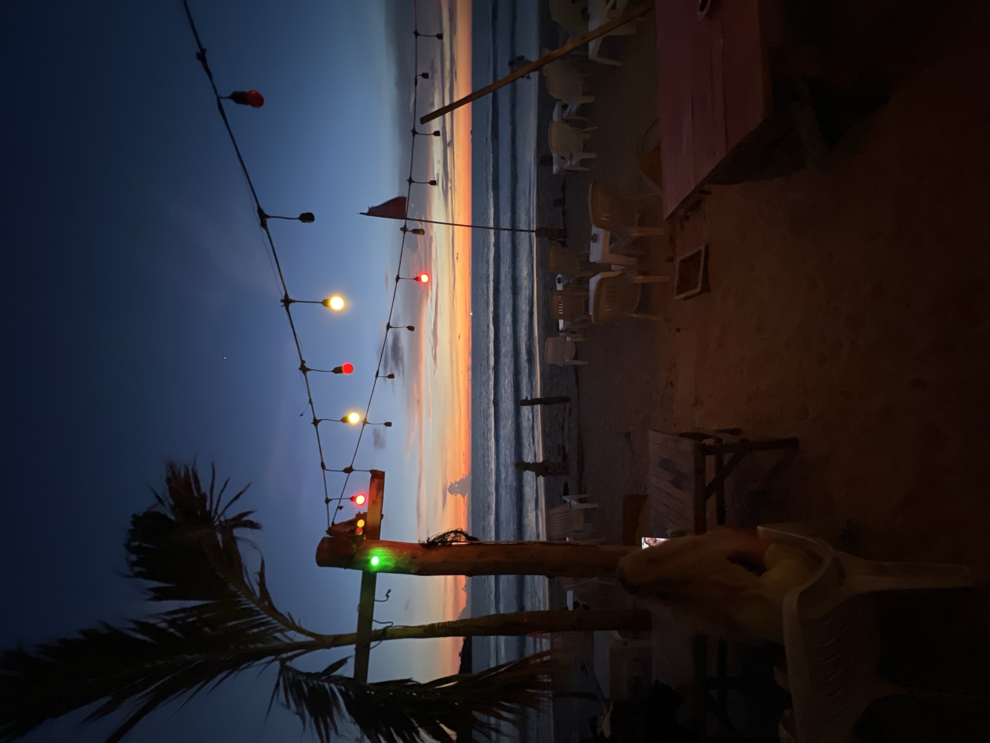 Fire performers spell "NOMAD" in flames at beach restaurant