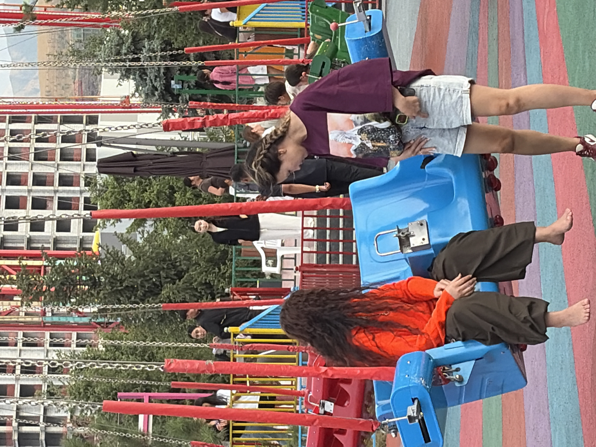 Busy afternoon at an amusement park as the sun goes down