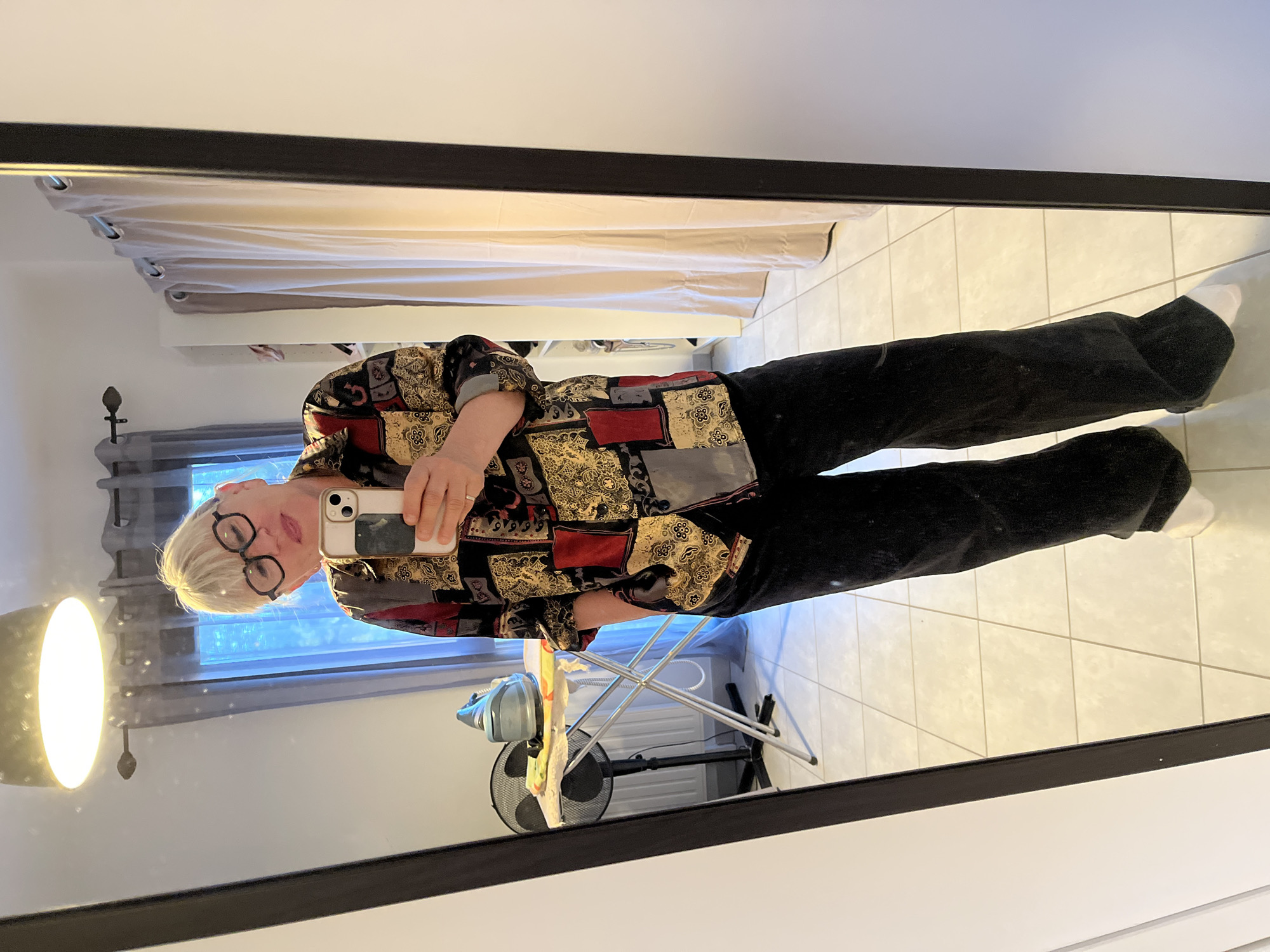 Woman takes mirror selfie in home in Chambœuf, France