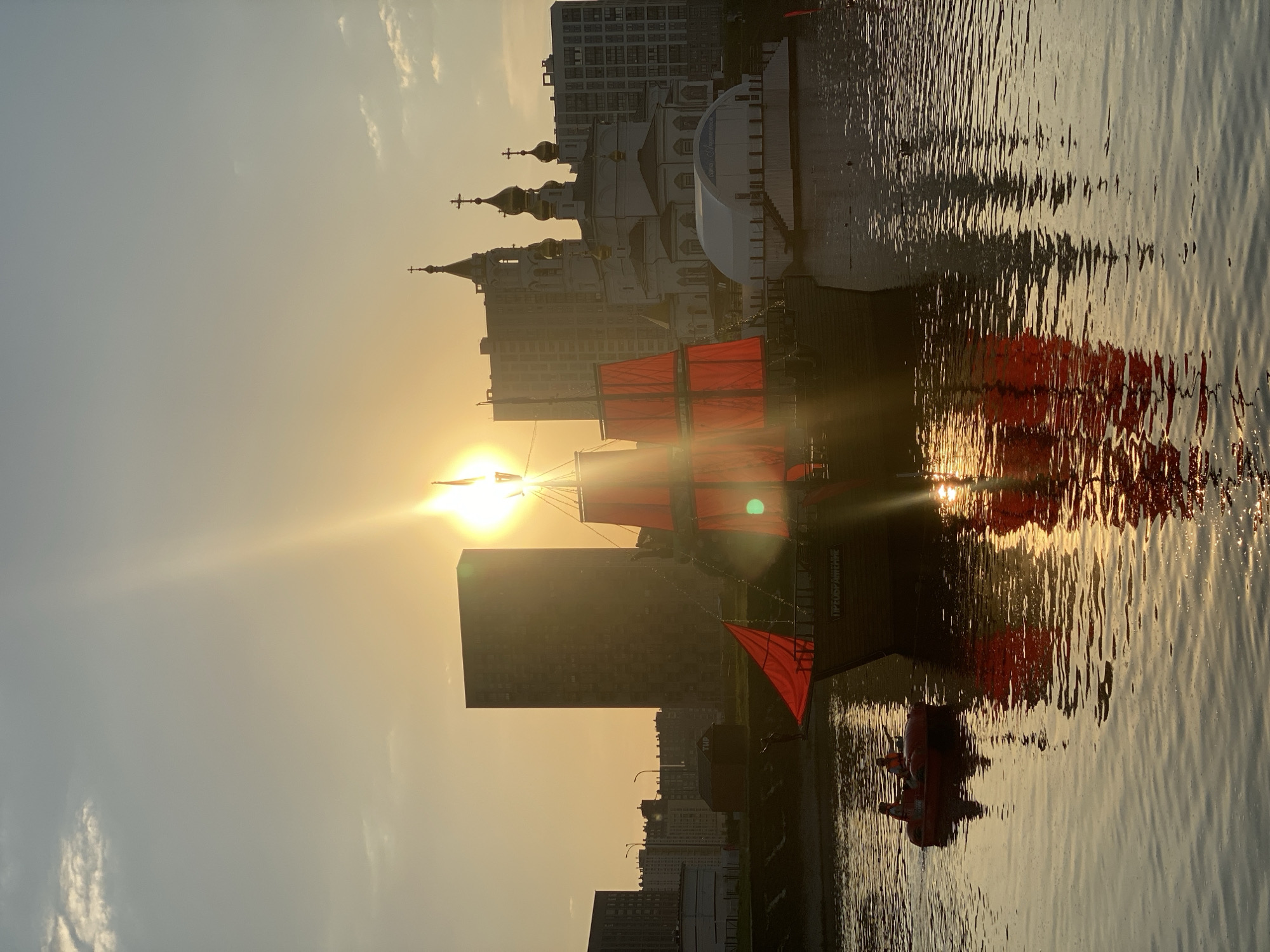 Red-sailed ship captures attention during Yekaterinburg waterfront sunset