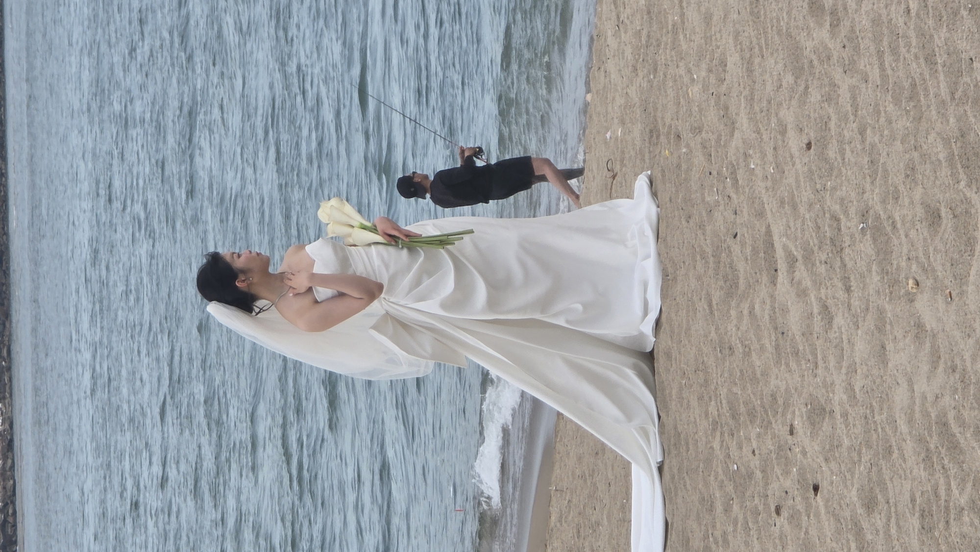 Beach wedding shoot in Nha Trang under a dramatic stormy sky