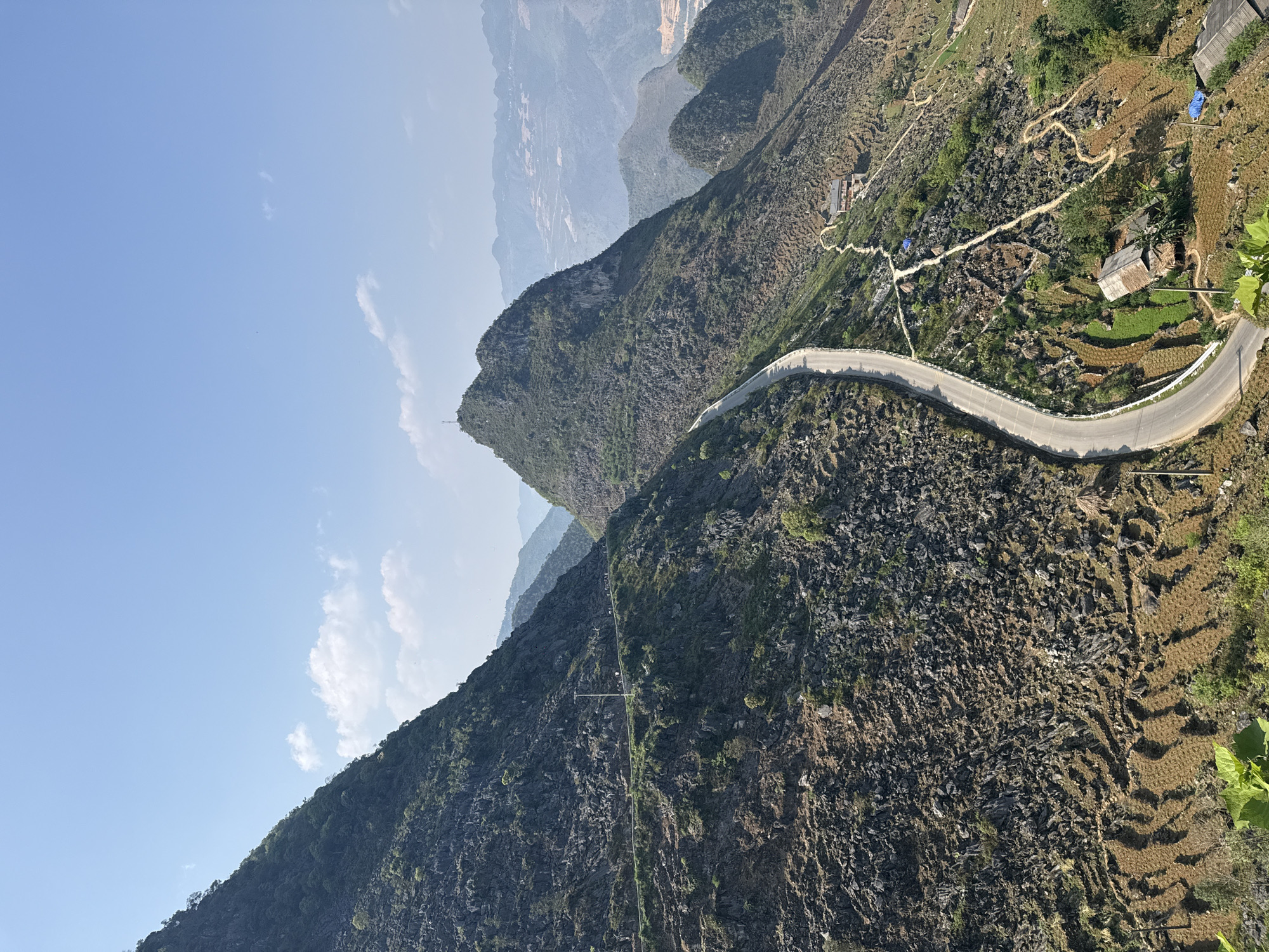Tourist photographs mountain road and terraces in northern Vietnam