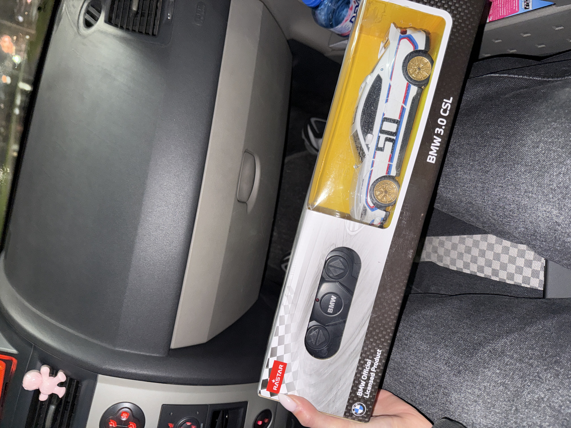 Driver displays BMW toy car in vehicle in Plovdiv
