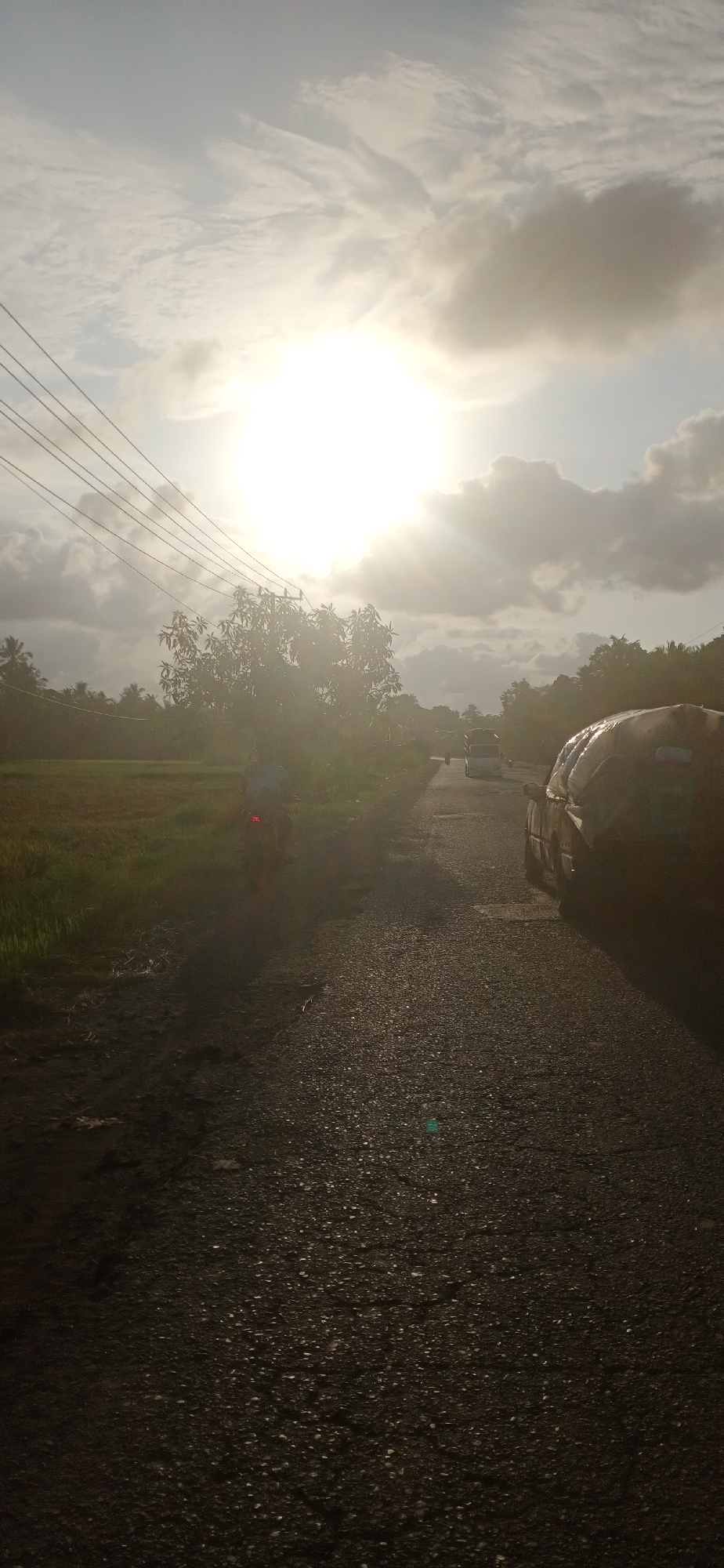 Sunlit rural road observed in Lhokseumawe, Indonesia