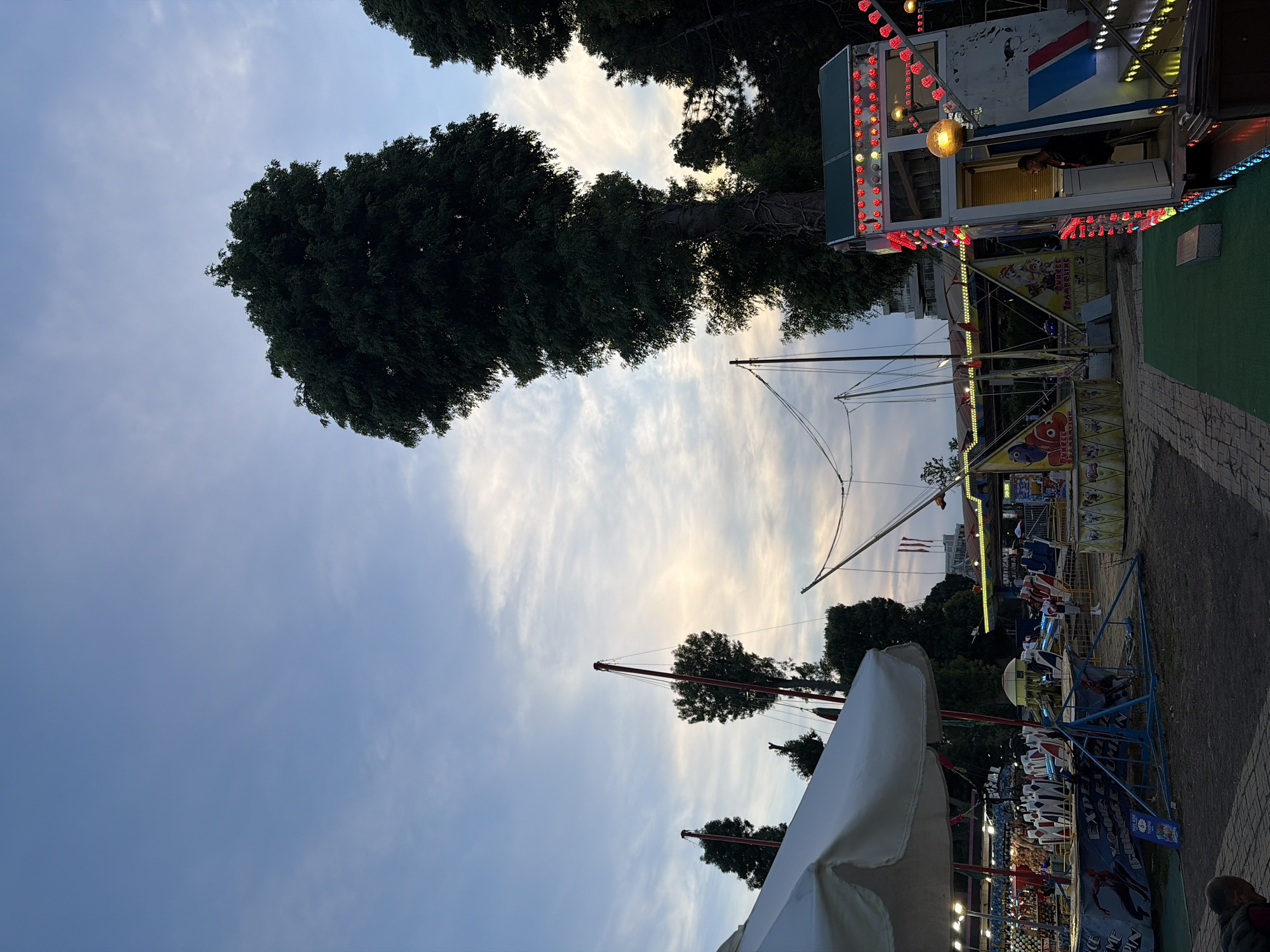 Evening amusement park operations captured across rides and vendors