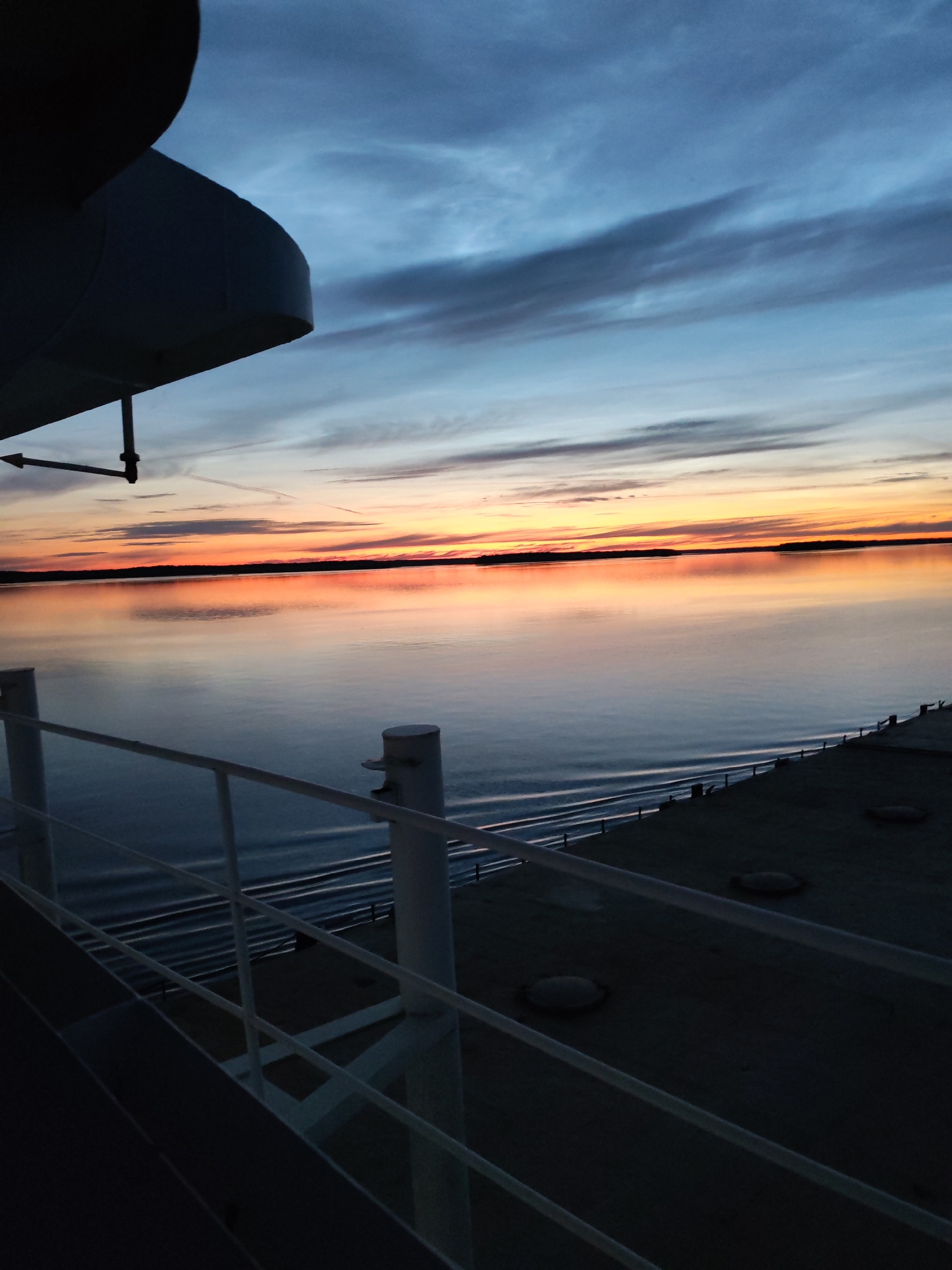 Full moon rising over the Sheksna River from a moving barge