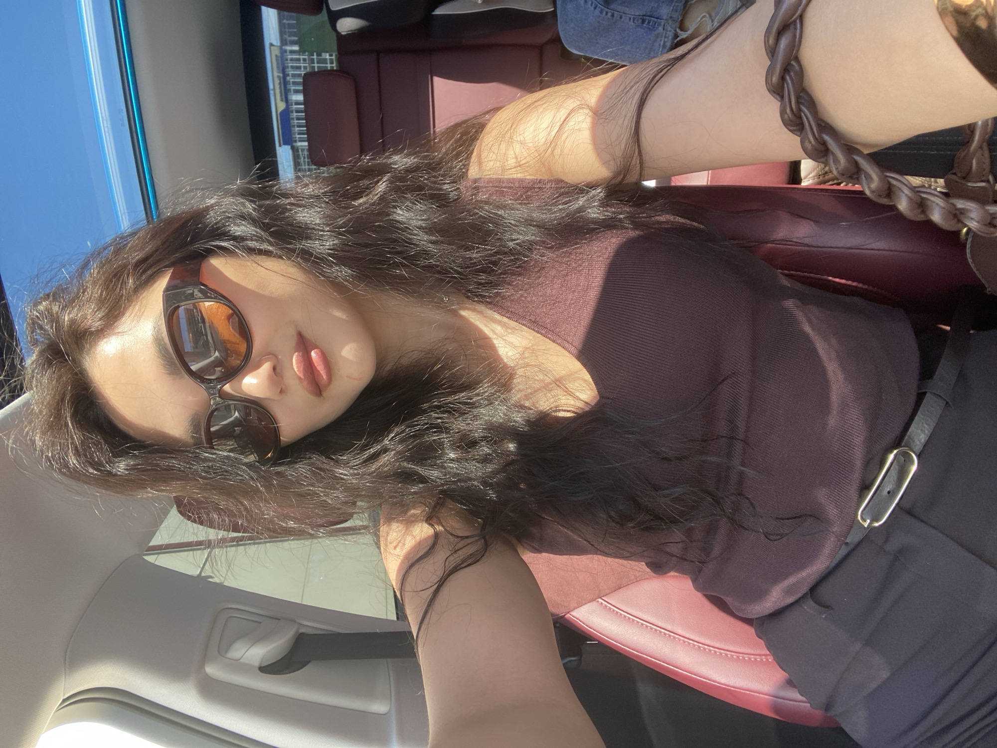 Woman takes casual selfies in car during sunny Sochi morning