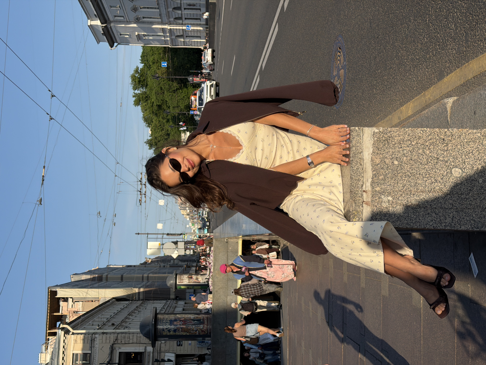 Woman enjoys sunny afternoon with flowers in Saint Petersburg