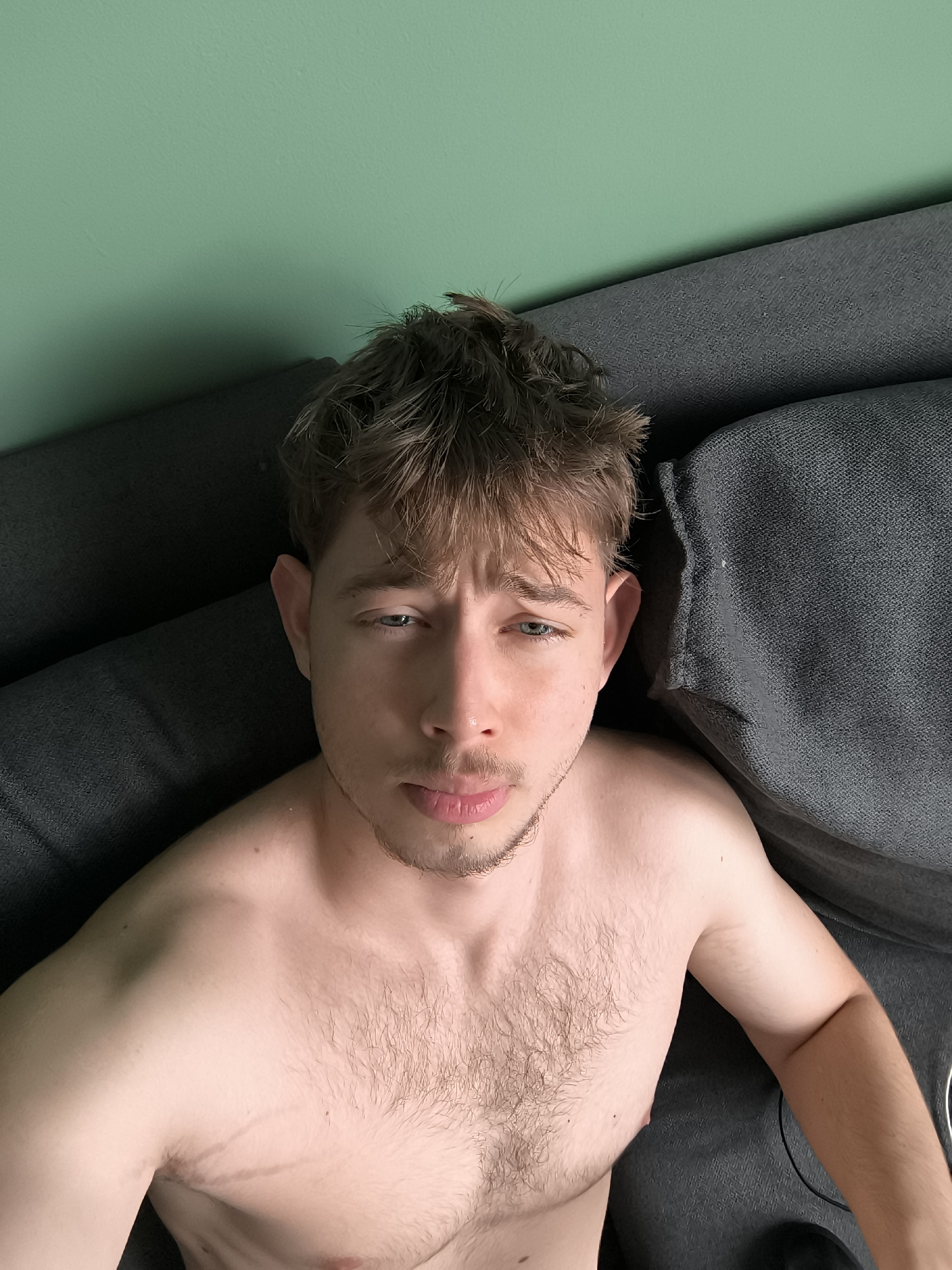 Man rests on couch in Sofia residence