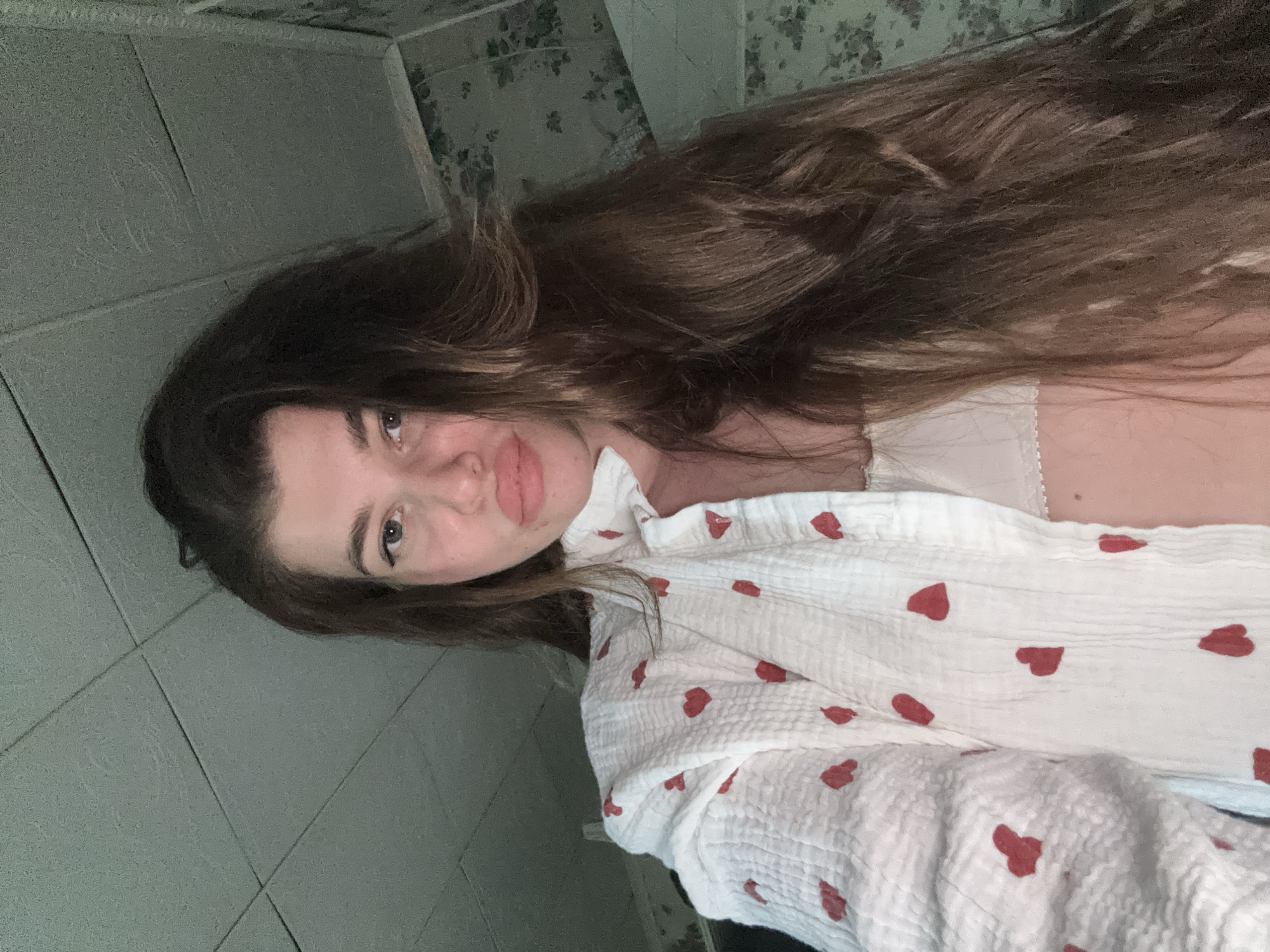 Woman photographs herself in bathroom in Мещёры, Russia