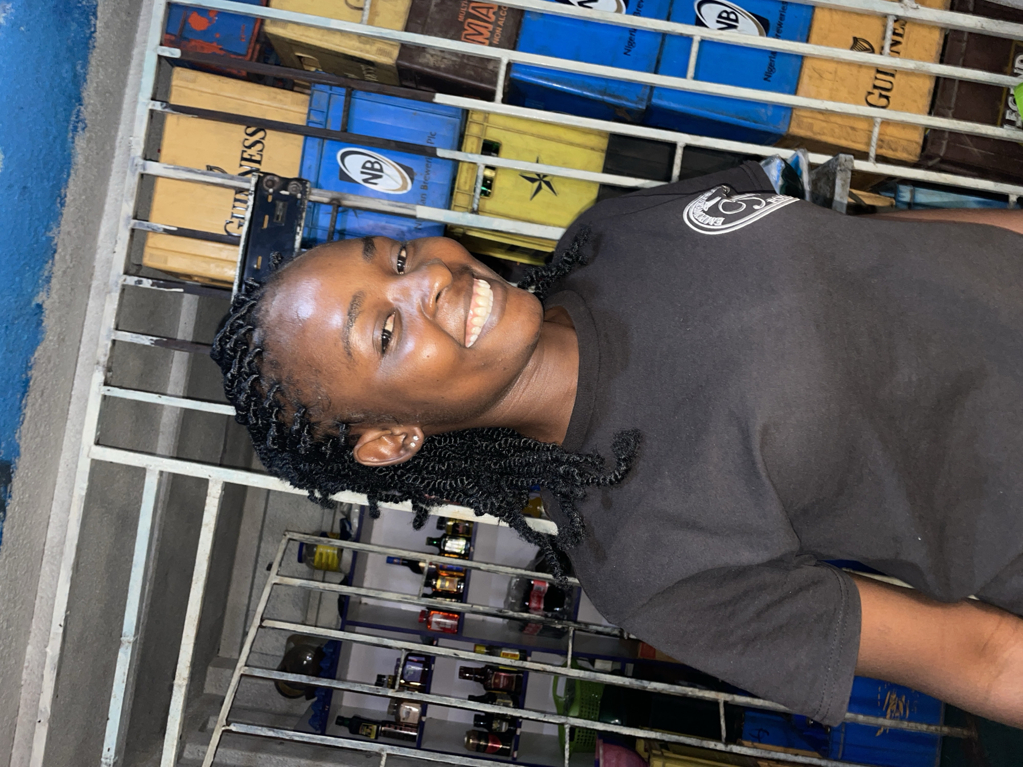 Young person photographed smiling at Jos beverage shop