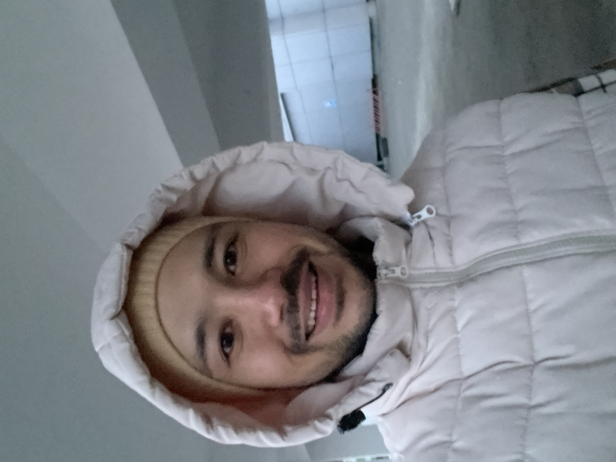 Man photographed smiling in Izhevsk building corridor