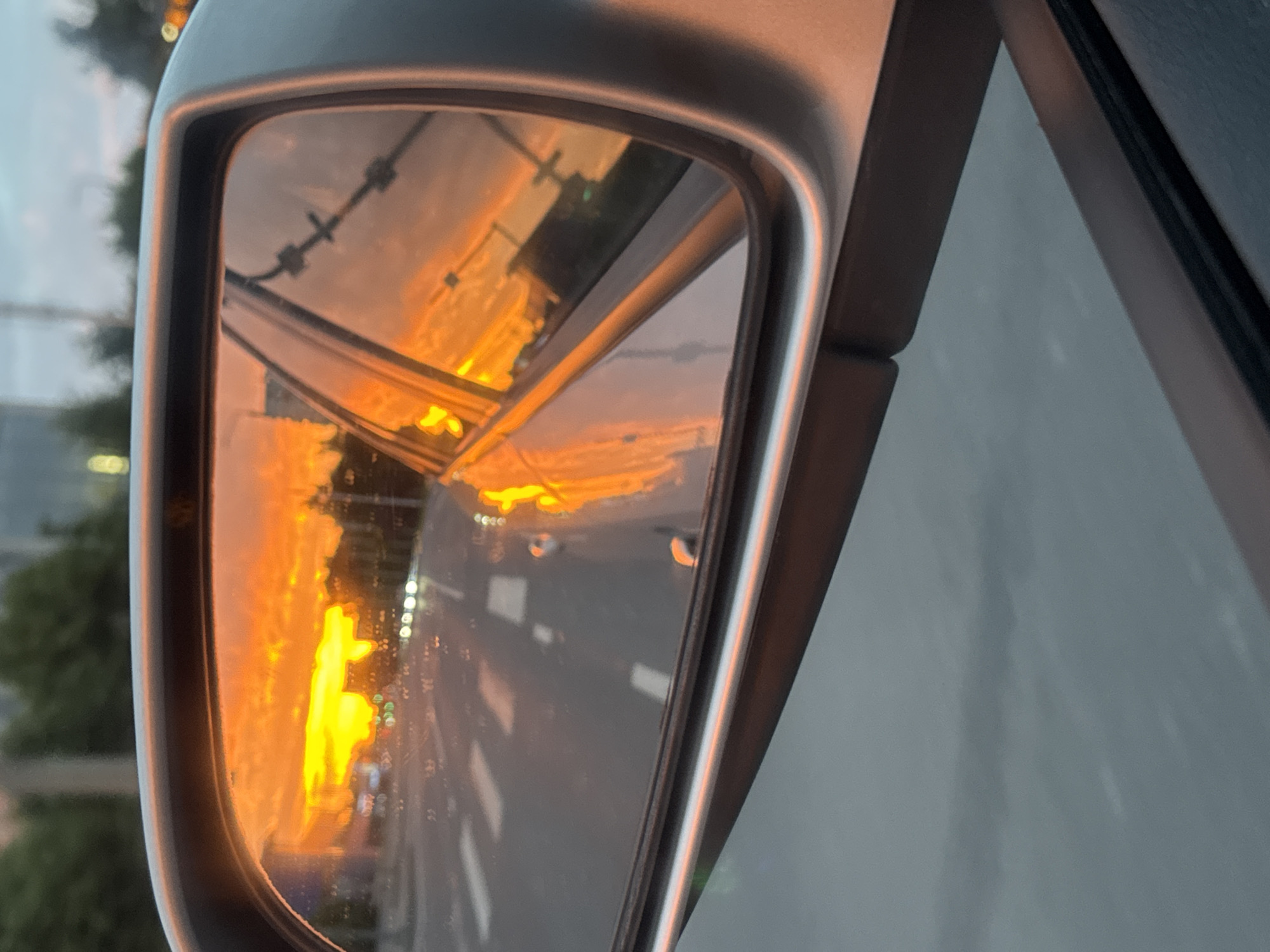 Tallinn sunset burns across streets, rooftops, and rearview mirrors
