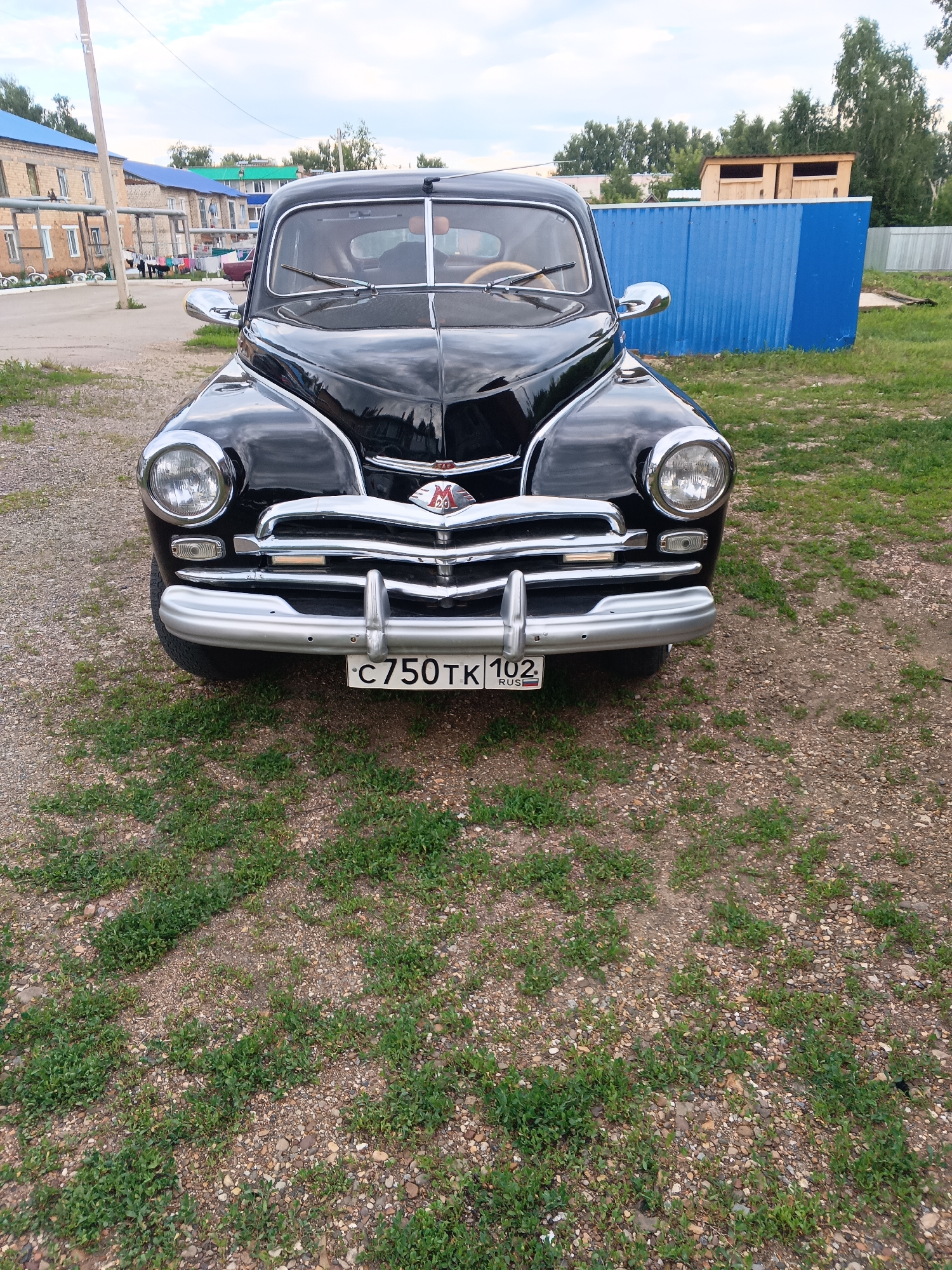 Vintage car and blooming garden in Tolbazy, Russia