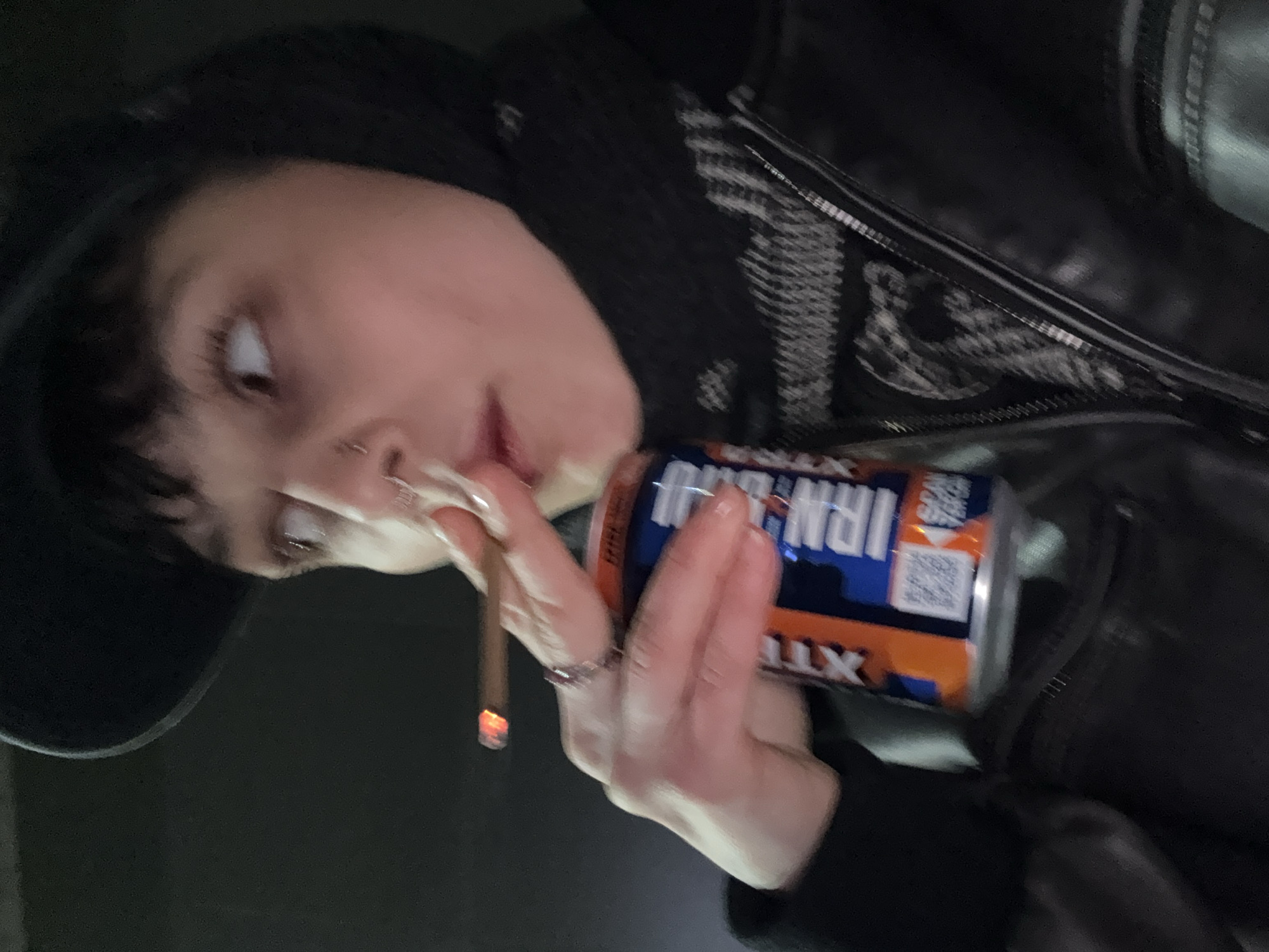 Person smoking cigarettes near overflowing ashtray in Moscow