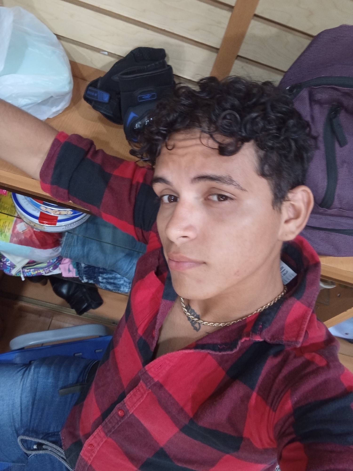 Young man takes multiple selfies in Juan Griego shop