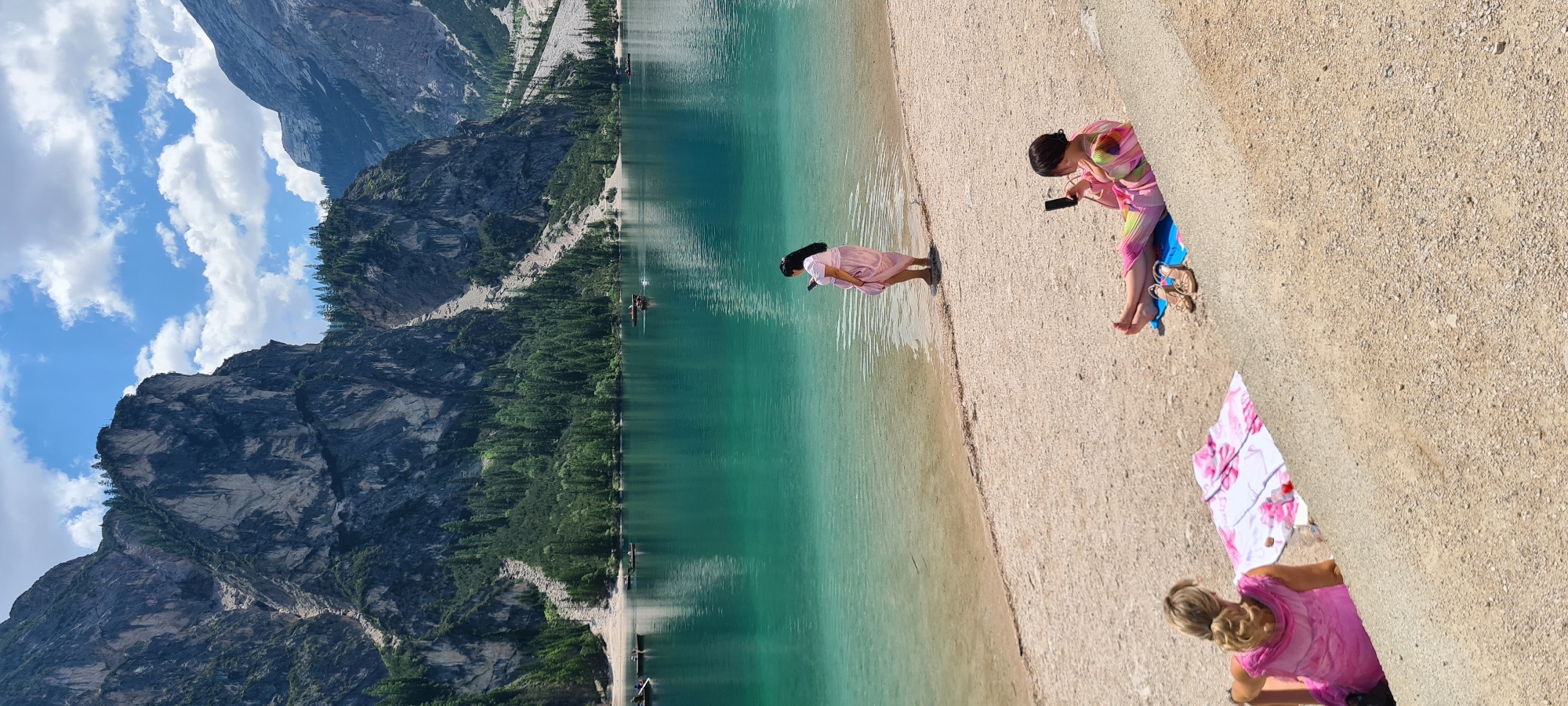 Morning at Lago di Braies, Dolomites — lake, peaks, and a dog
