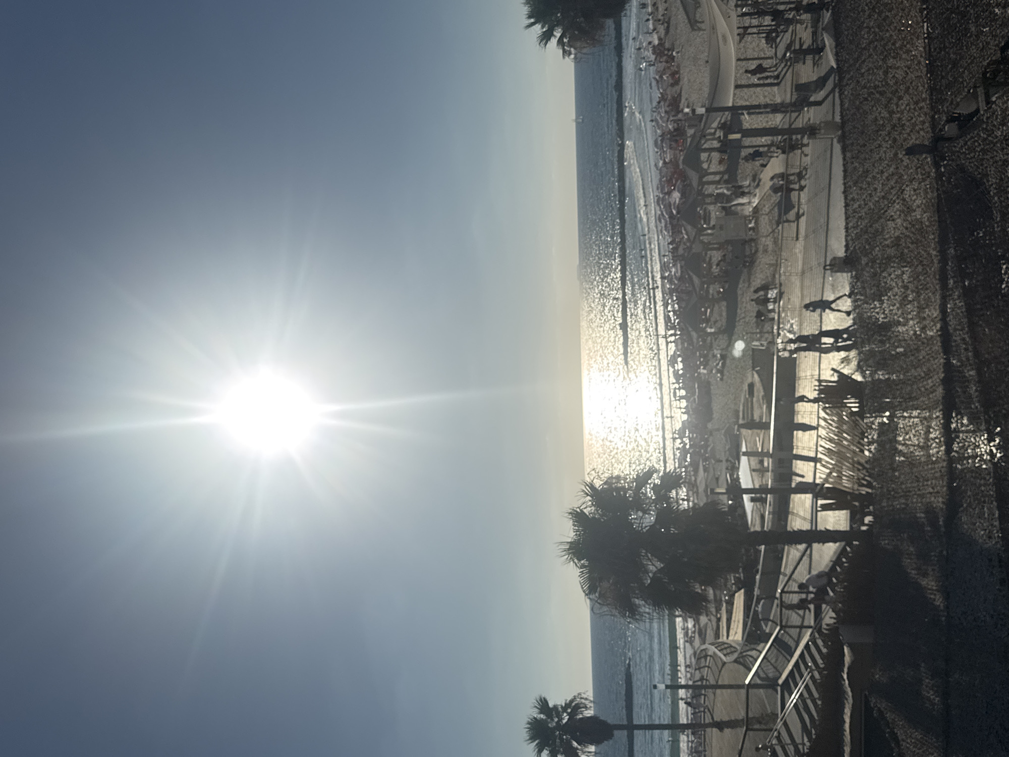 Bright afternoon sun and shade on a Tel Aviv beach