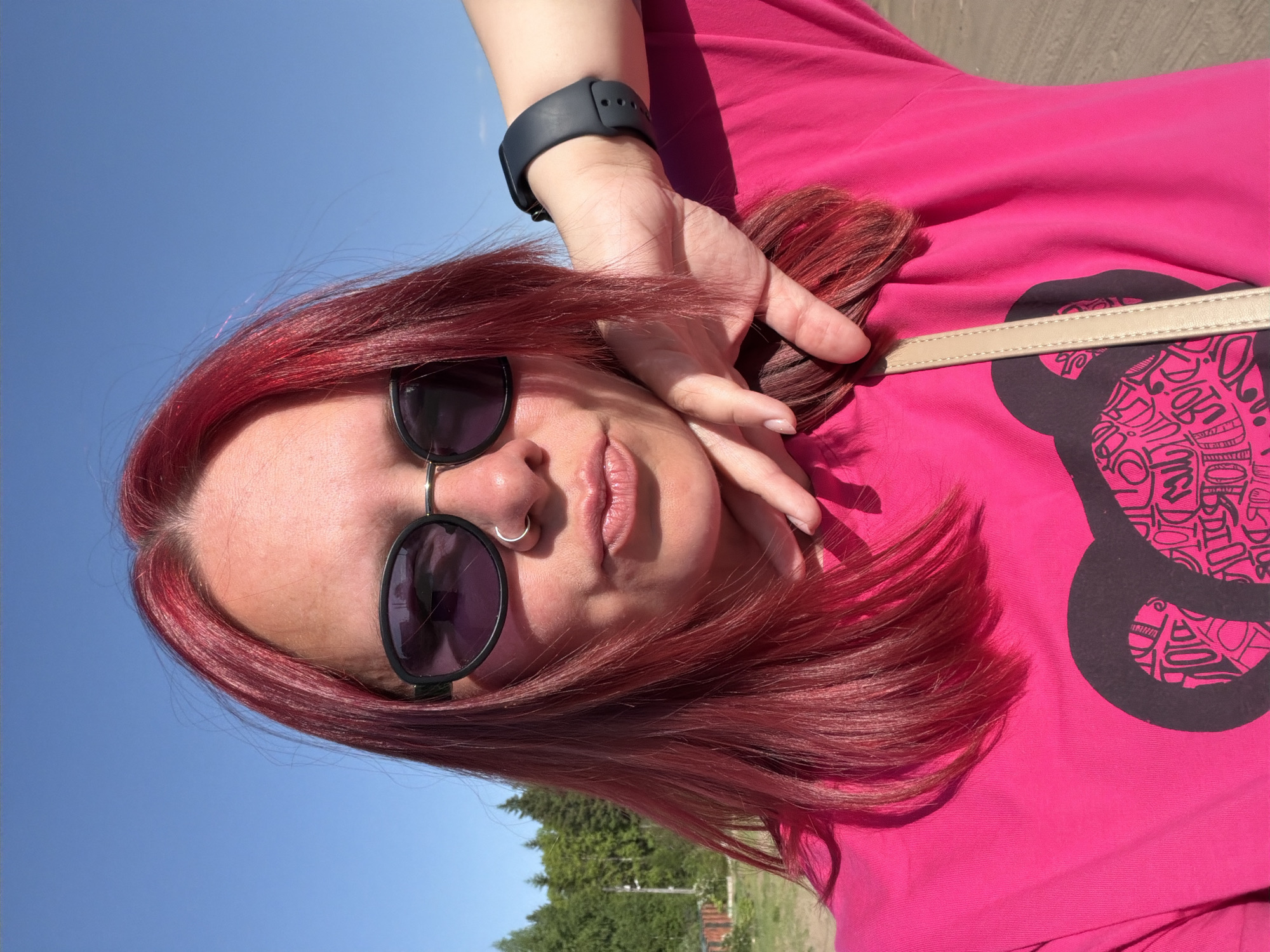 Woman takes outdoor selfies in sunny Chaikovsky, Russia