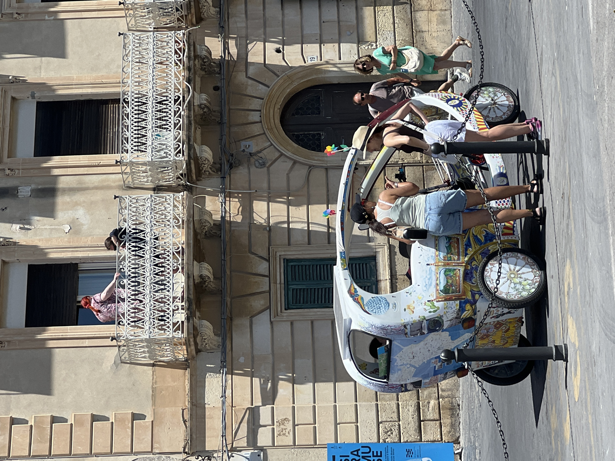 Exploring Syracuse's historic Ortigia district on sunny afternoon