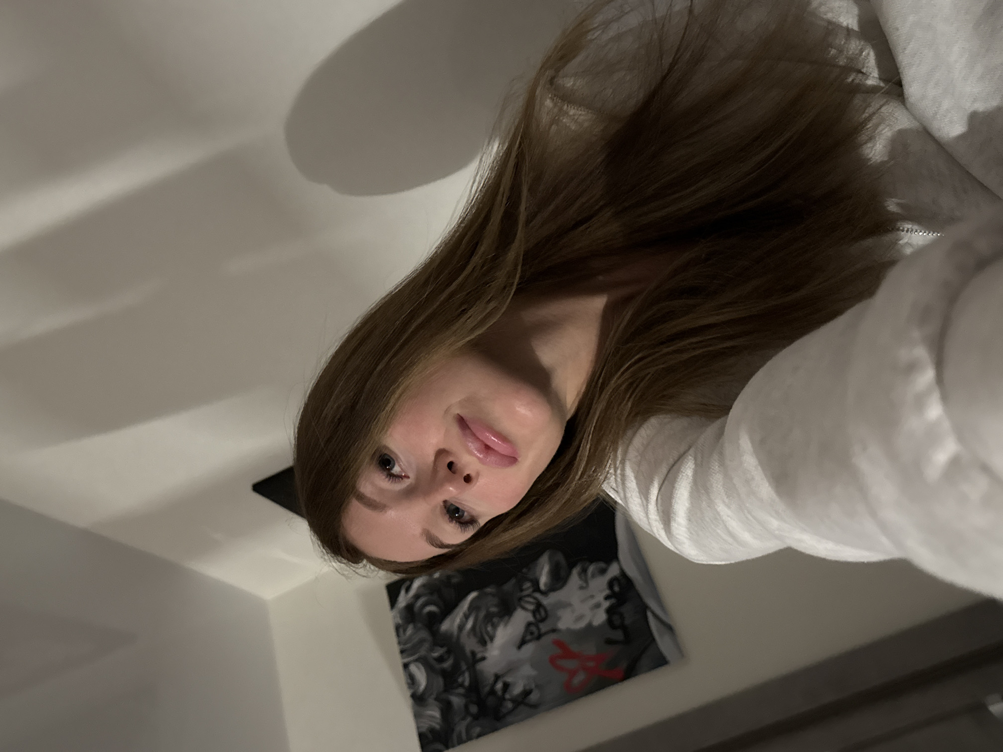 Woman takes selfie in gray hoodie in Chaikovsky, Russia
