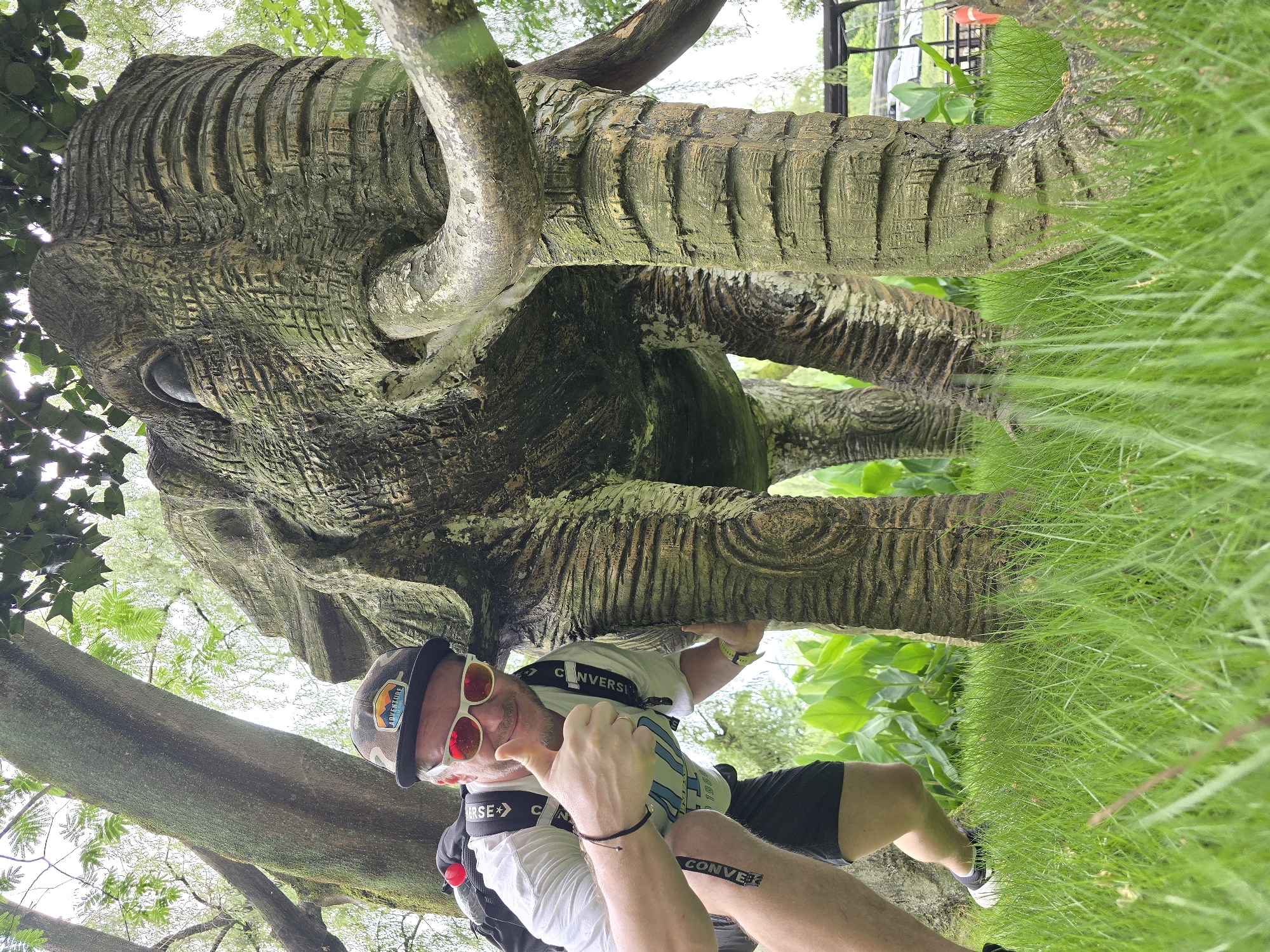 Tourist poses with elephant statue in Xihu District