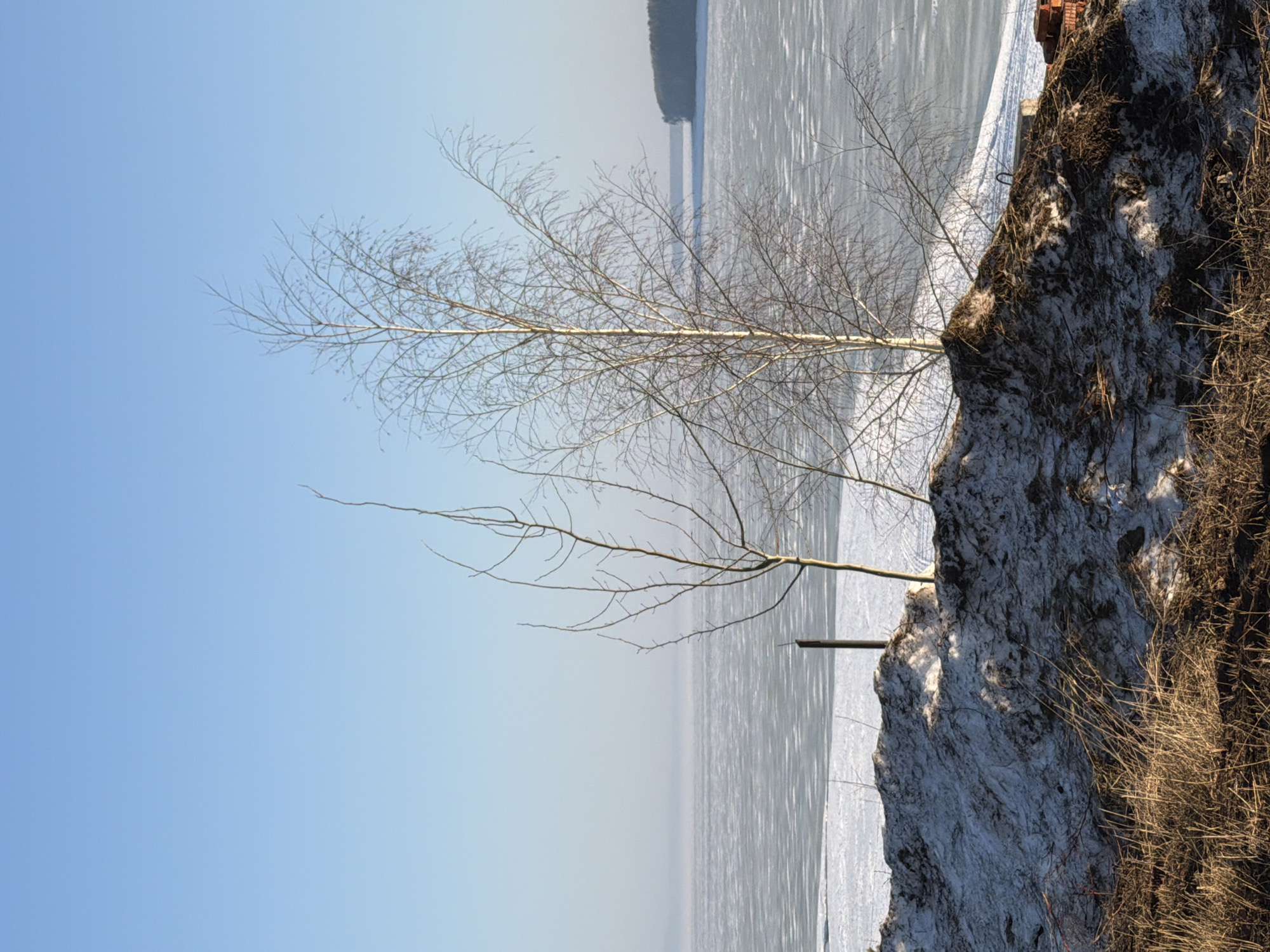 Woman documents winter riverside scenery in Chaikovsky, Russia