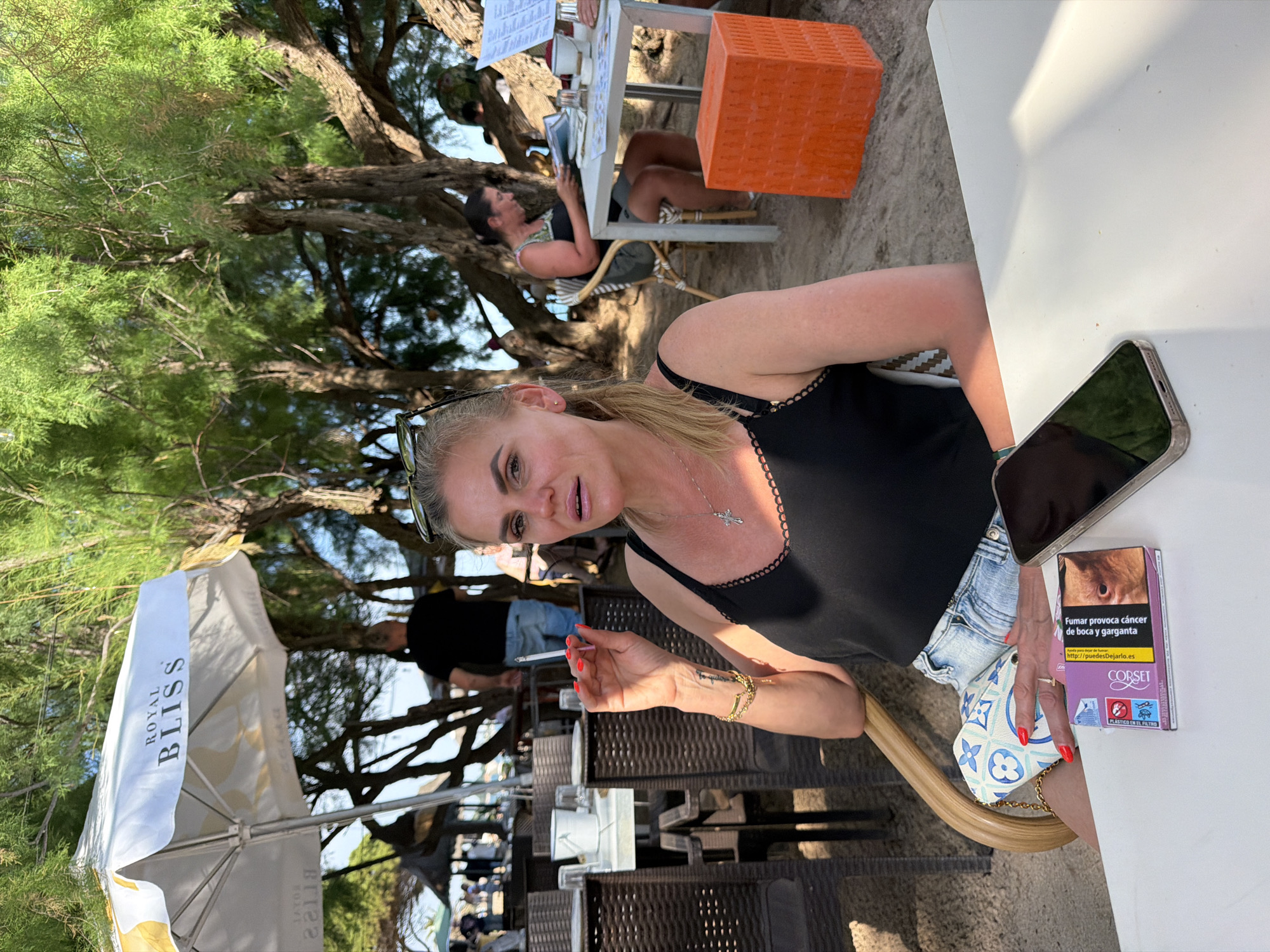 Woman dines at beachfront restaurant in Mont-roig del Camp
