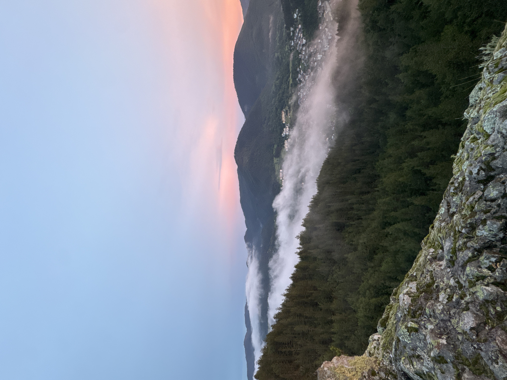 Sunset over Smolyan valley, framed by a hilltop metal cross