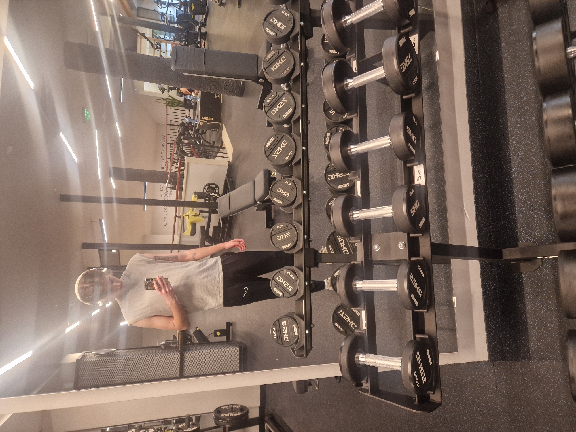 Person spotted in gym mirror reflection