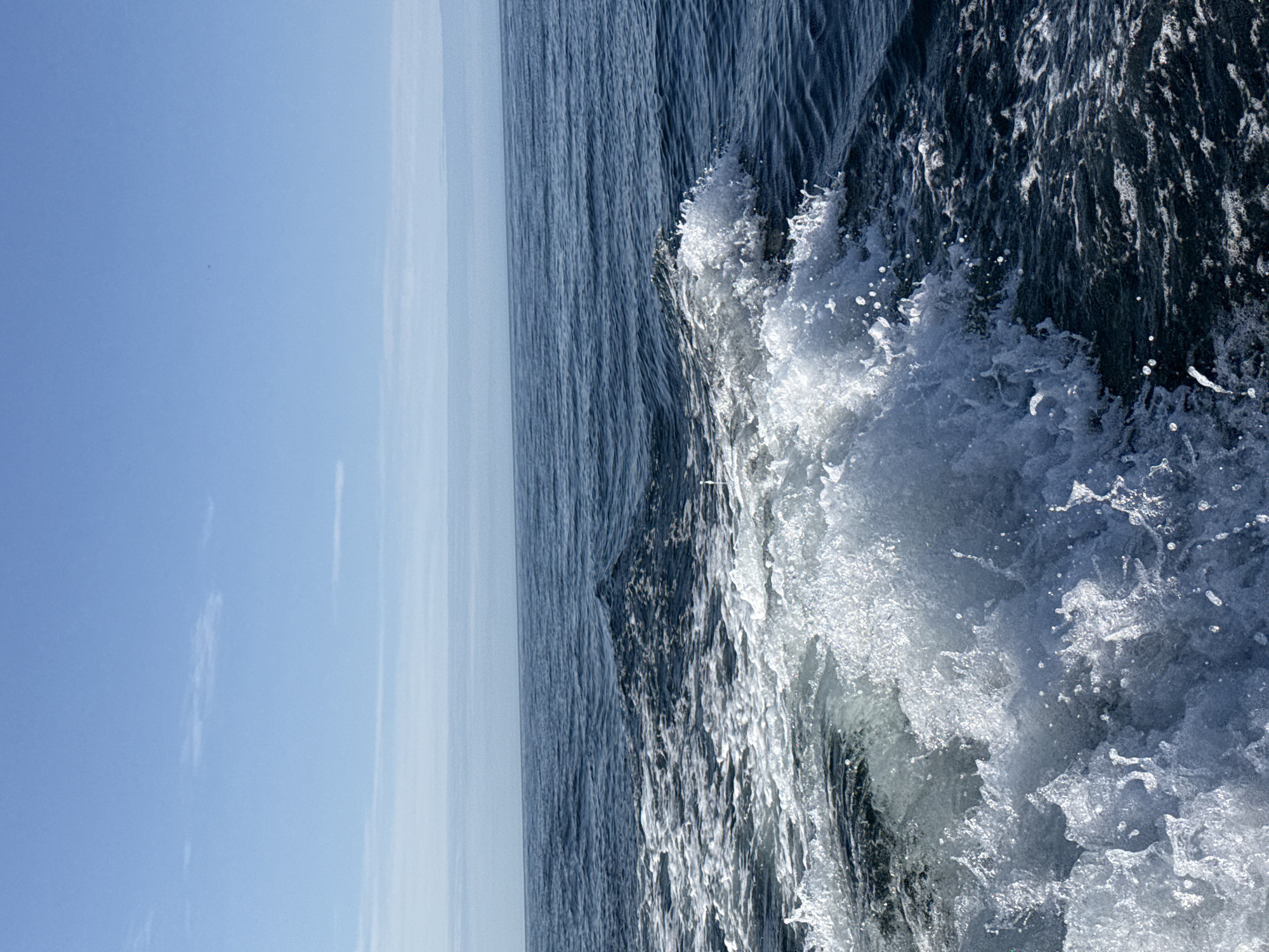 Choppy wake and white foam on Arctic waters near Teriberka