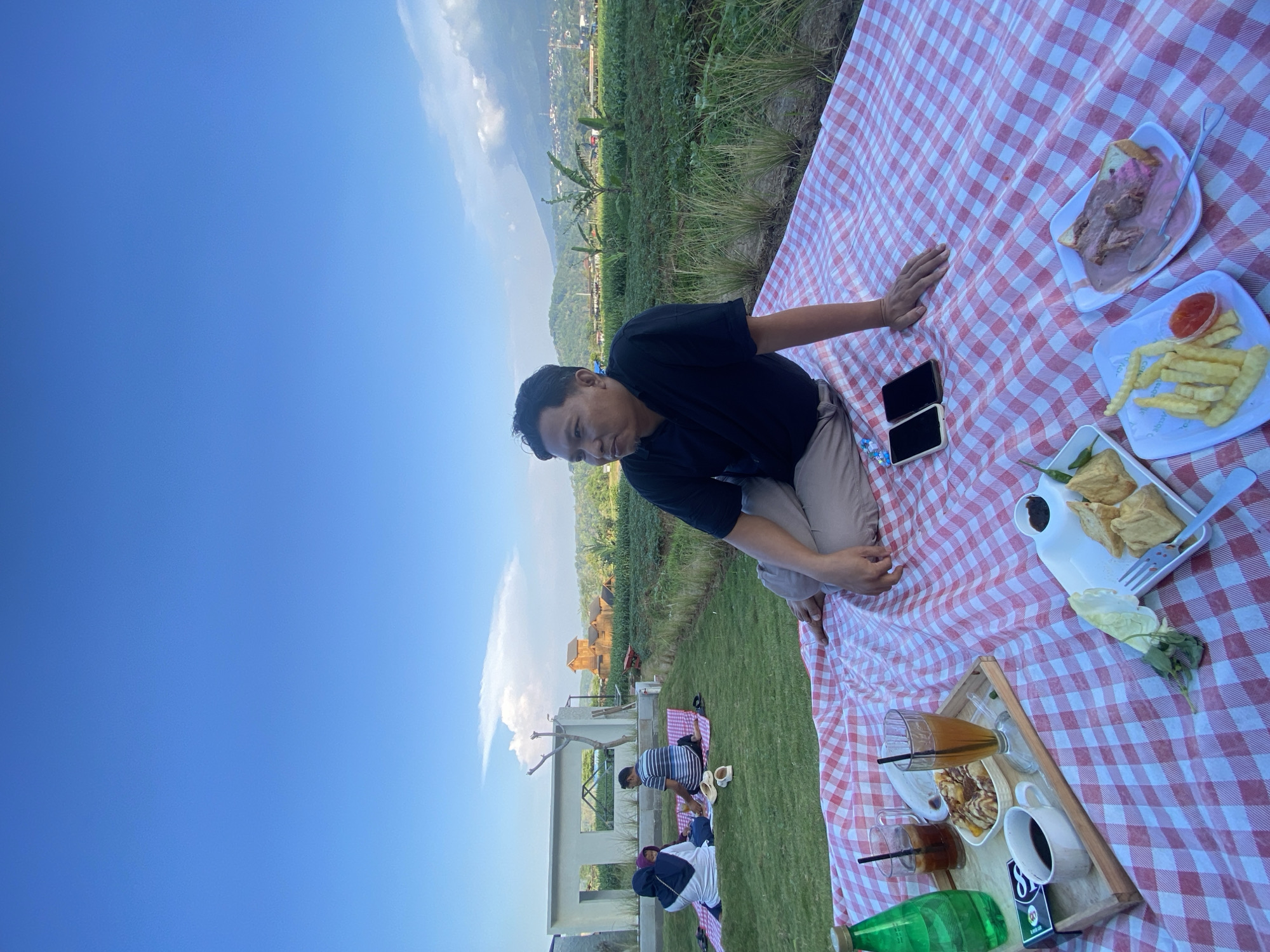 Family picnic on terraced farmland in Kesiman, Indonesia