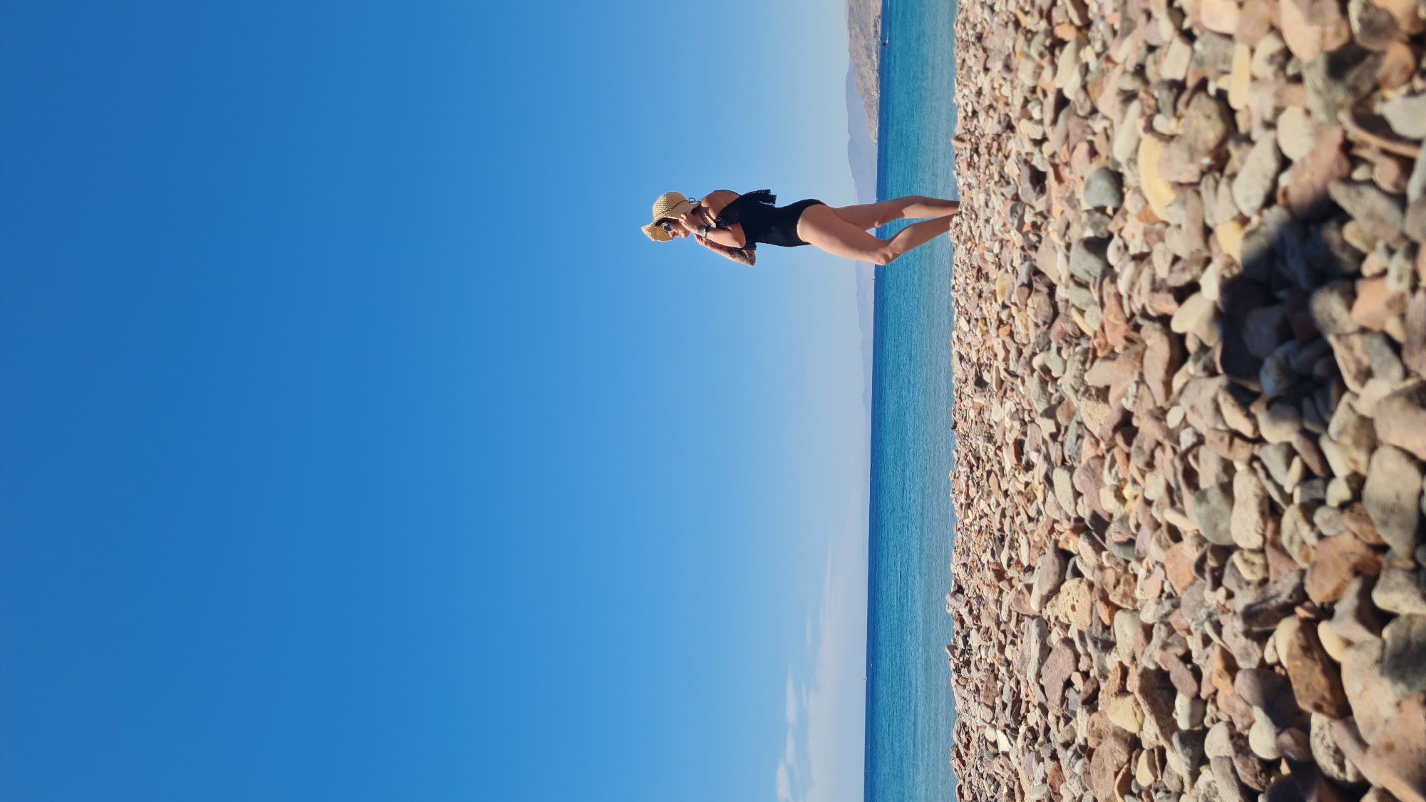 Woman enjoys morning beach moments in Eilat, Israel